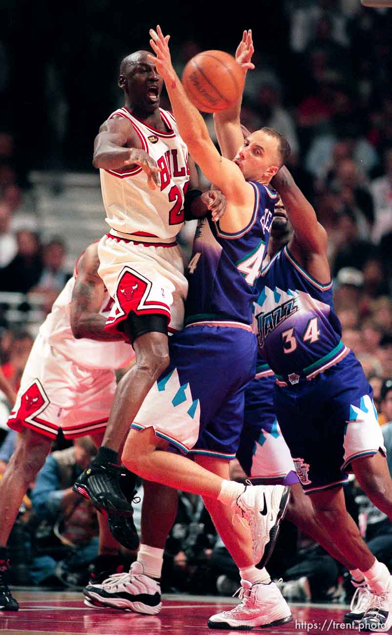 Michael Jordan passes through Greg Foster's arms at Jazz vs. Bulls, game 4 of the NBA Finals. Bulls won