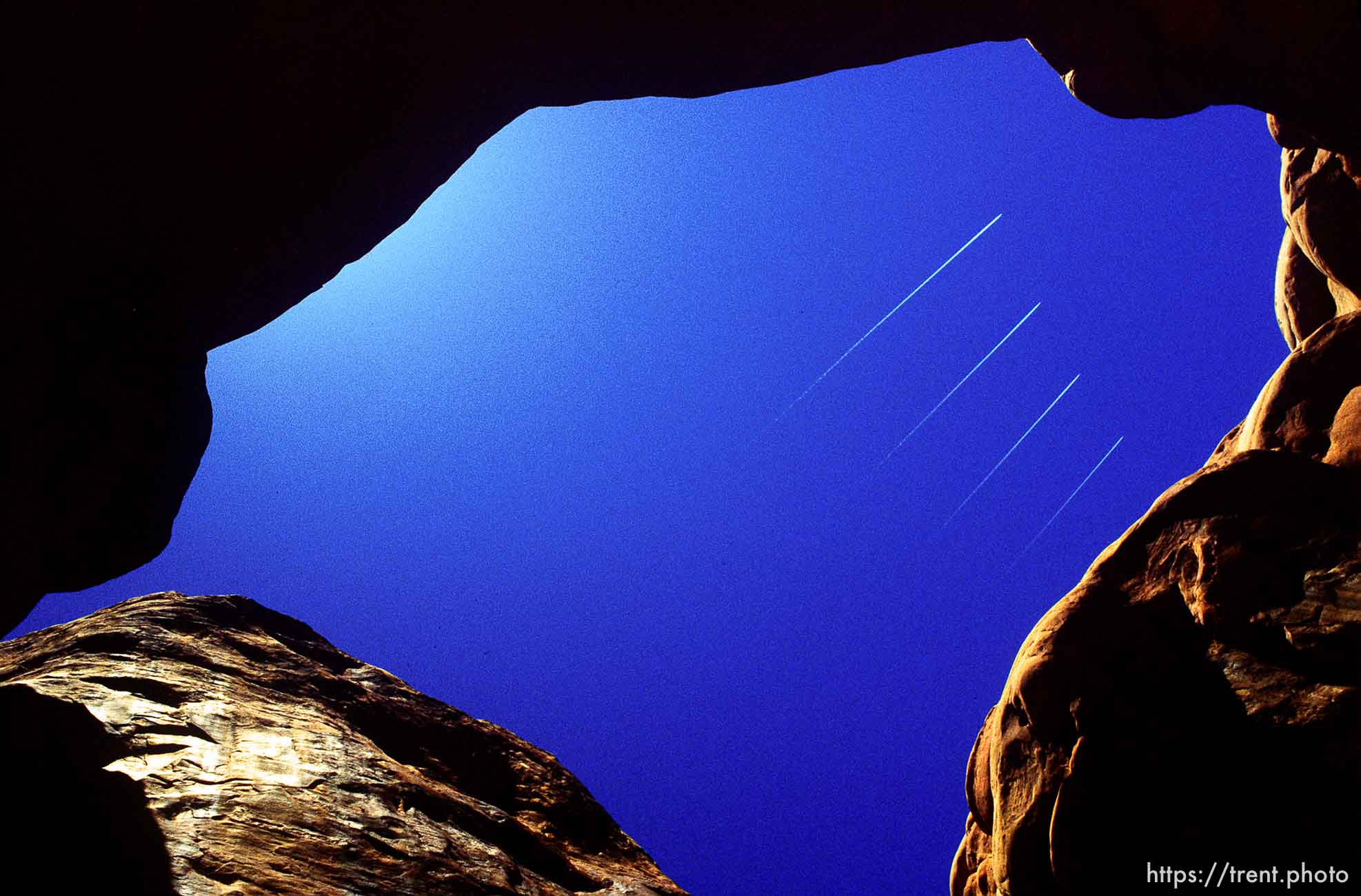 Planes fly over Double Arch in Arches National Park.