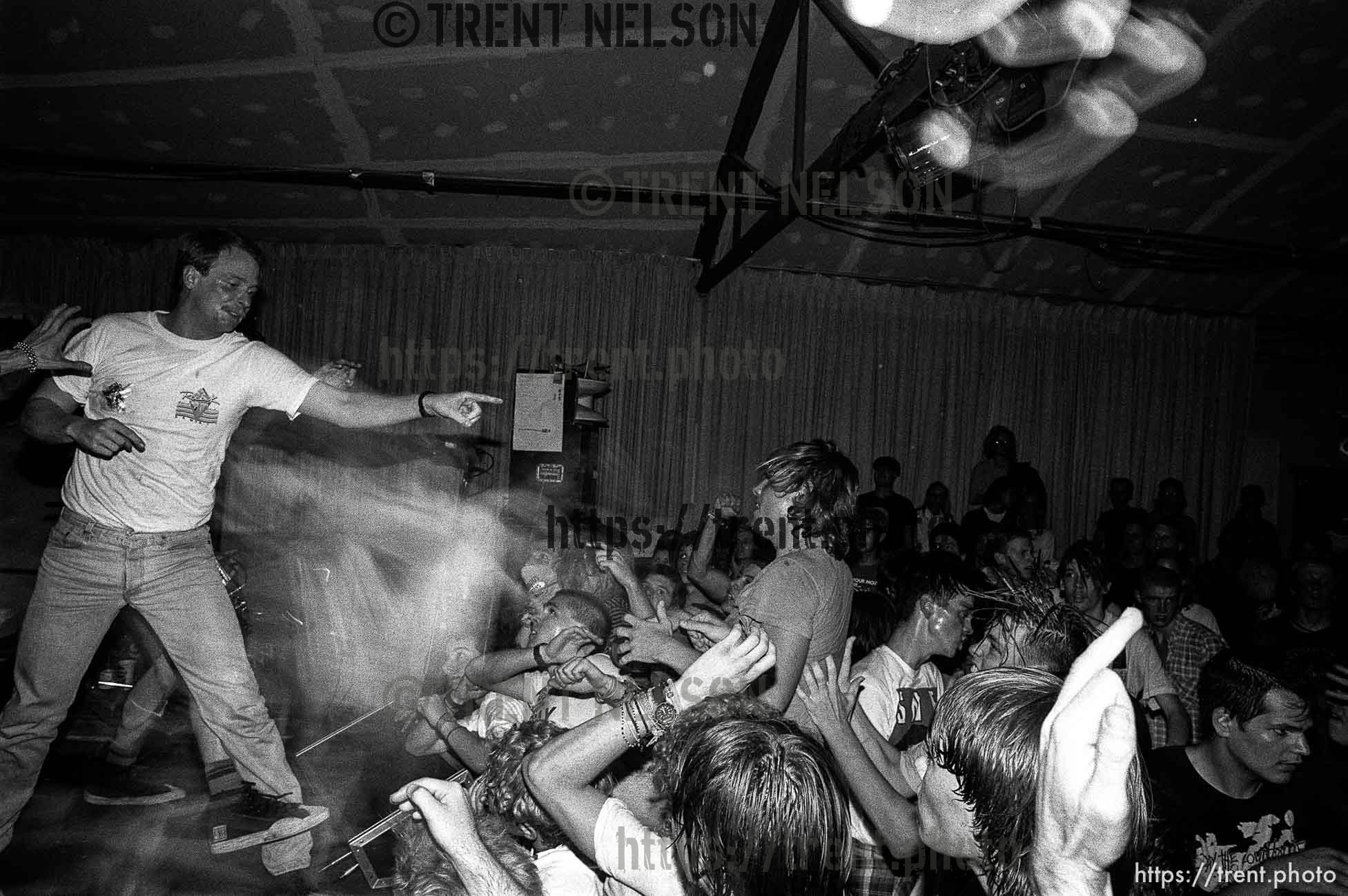 Security fighting with stage-diver and crowd at the SNFU concert at the Speedway Cafe.