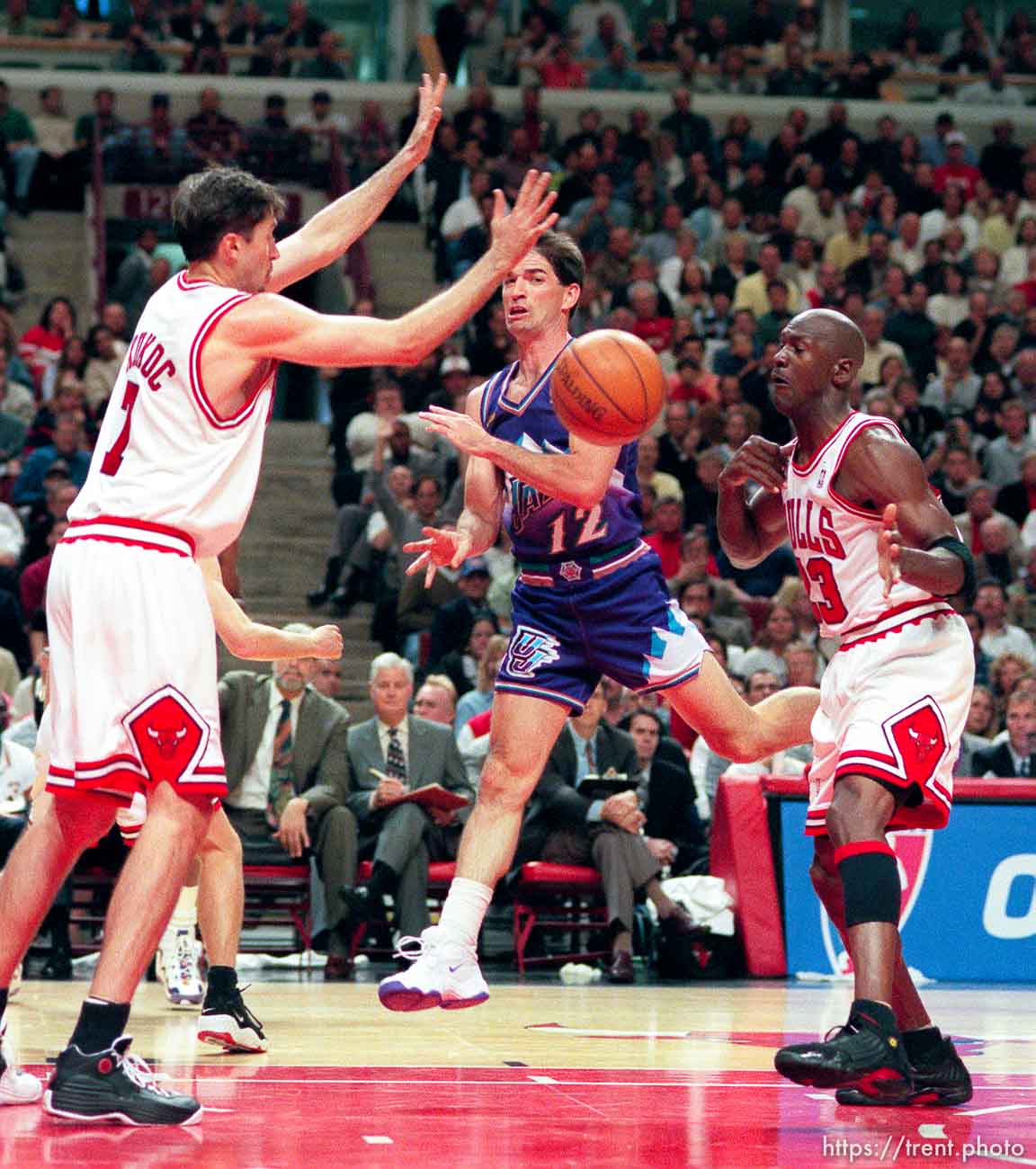 John Stockton passes through Toni Kukoc and Michael Jordan at Jazz vs. Bulls, game 3 of the NBA Finals. Bulls won