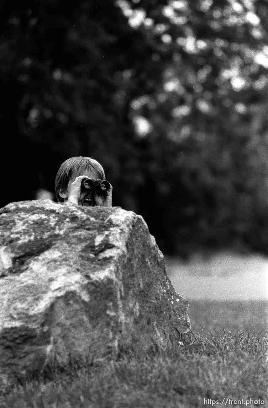 Kid watching out with binoculars while playing with guns outside our apartment. Two kids playing with guns outside our apartment.  Erik Finn, 8