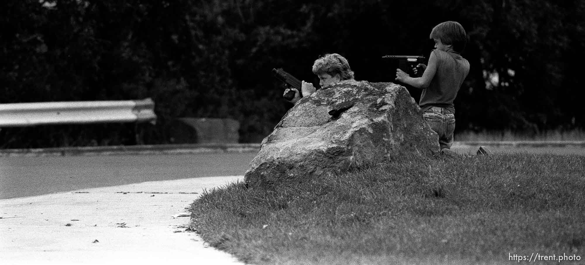 Two kids playing with guns outside our apartment. Two kids playing with guns outside our apartment. Kris Maxfield, 11, in white shirt, and Erik Finn, 8, in gray shirt