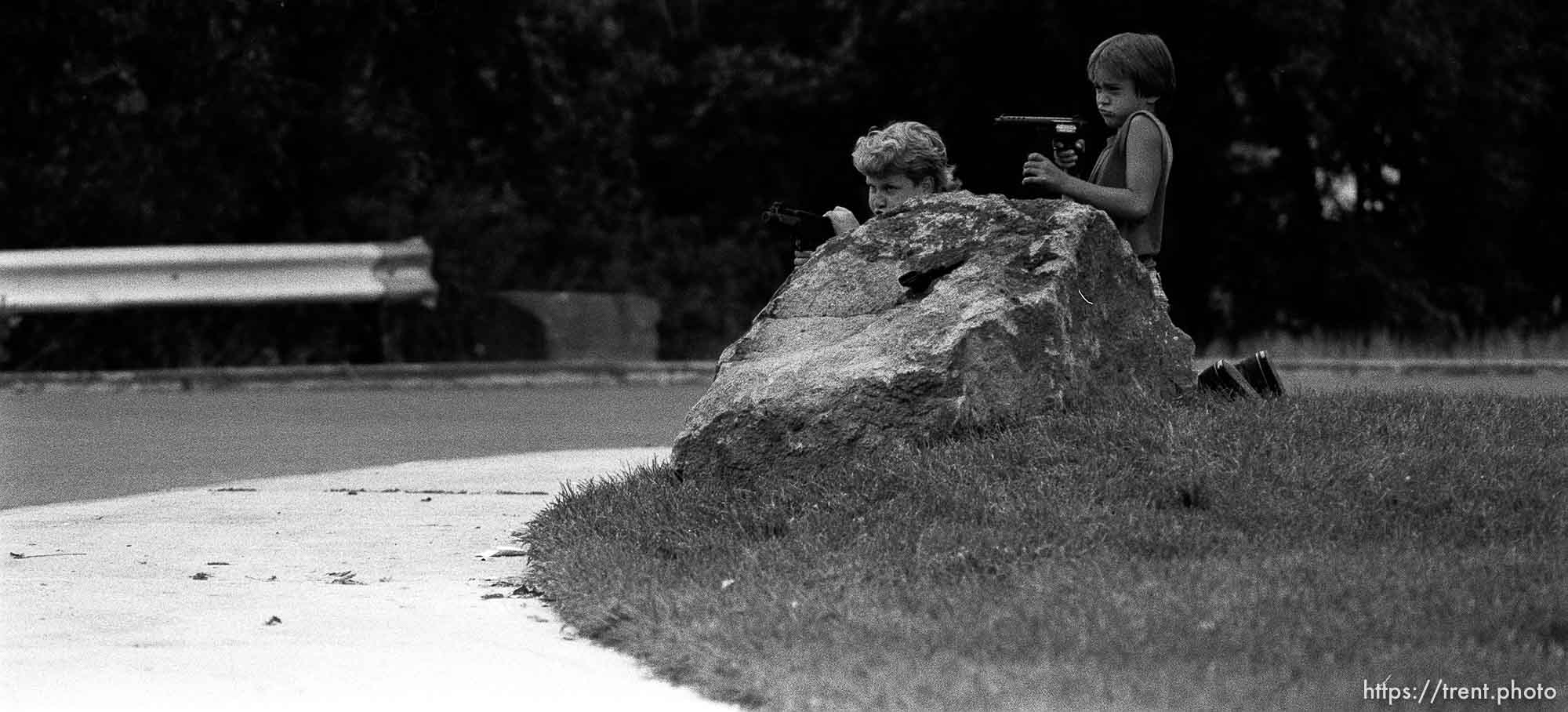 Two kids playing with guns outside our apartment. Two kids playing with guns outside our apartment. Kris Maxfield, 11, in white shirt, and Erik Finn, 8, in gray shirt