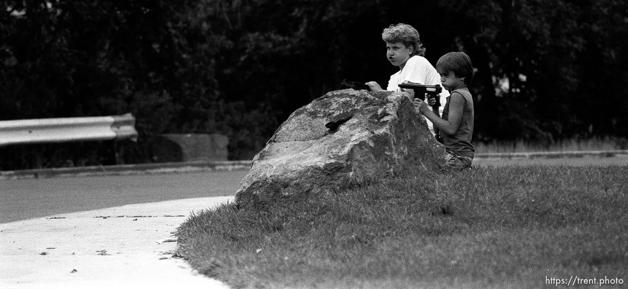 Two kids playing with guns outside our apartment. Two kids playing with guns outside our apartment. Kris Maxfield, 11, in white shirt, and Erik Finn, 8, in gray shirt