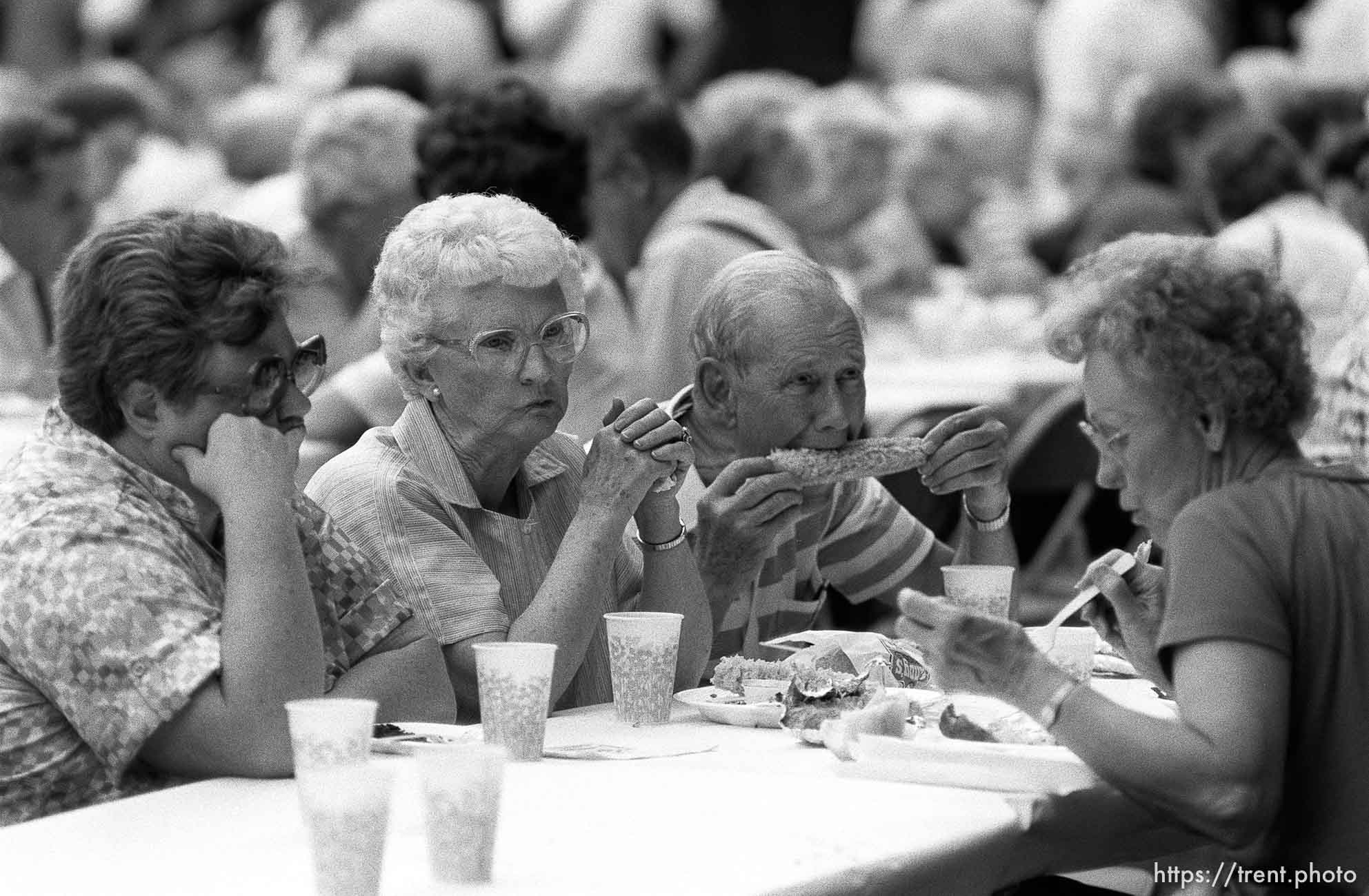 Guy eating corn at 34th annual Salmon Supper at Memorial Park.