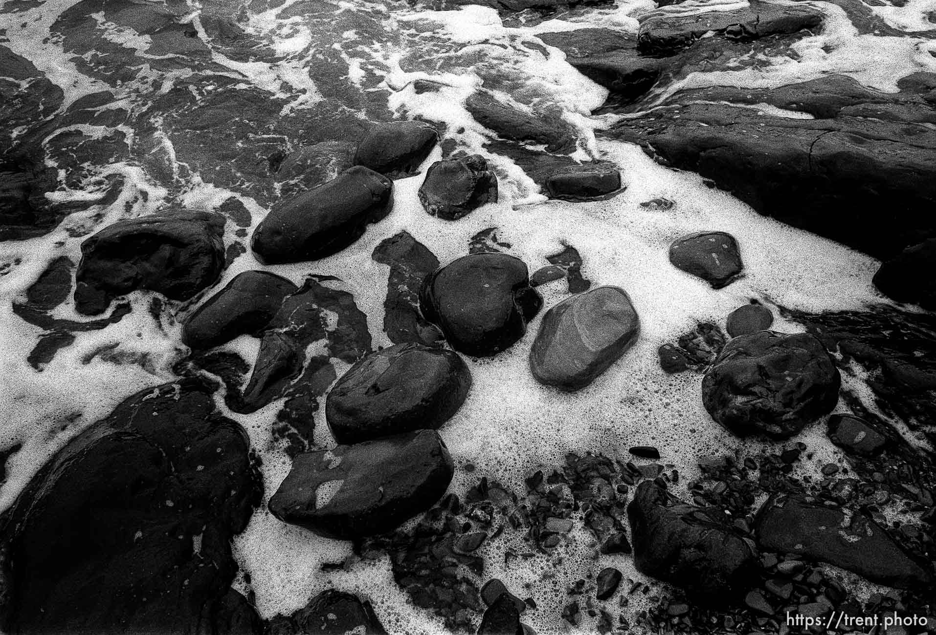 rocks and surf at beach.