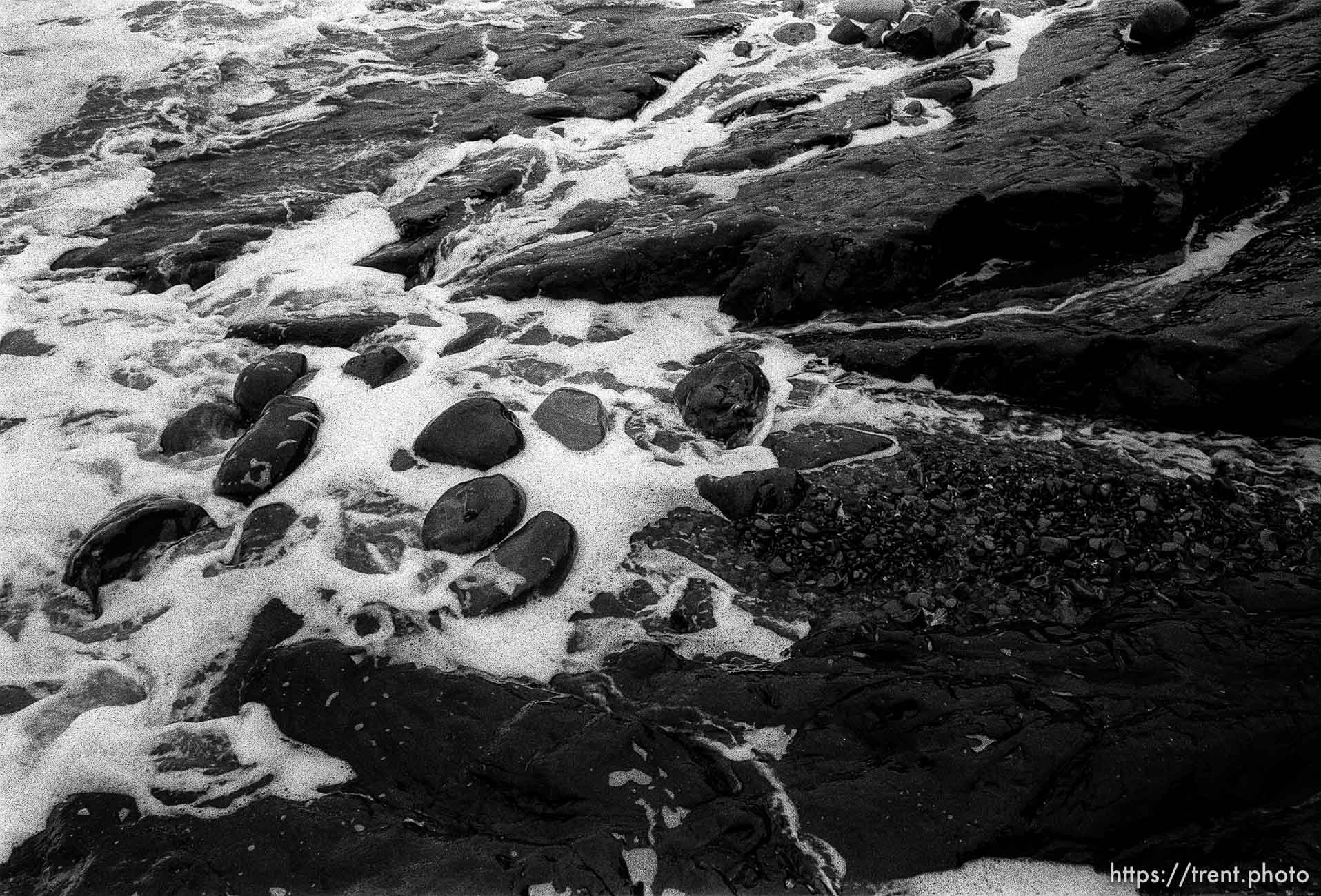 rocks and surf at beach.