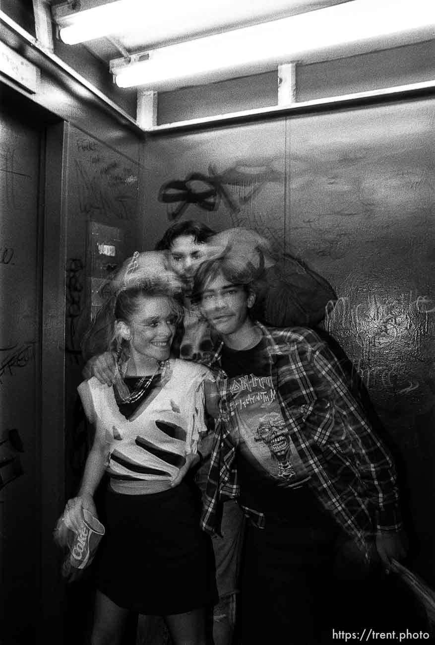 People in elevator posing.