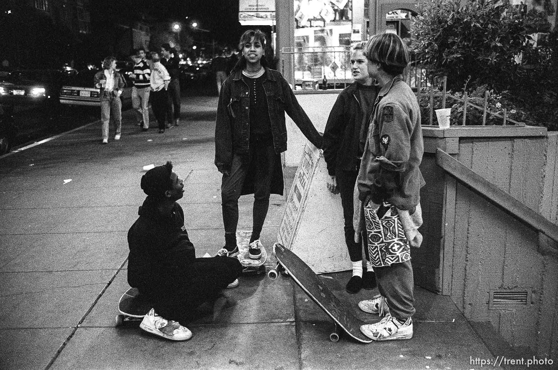 Skate punks on Telegraph Avenue at night.