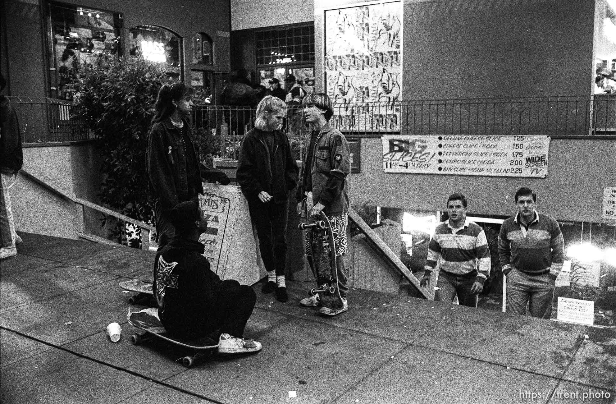 Skate punks on Telegraph Avenue at night.