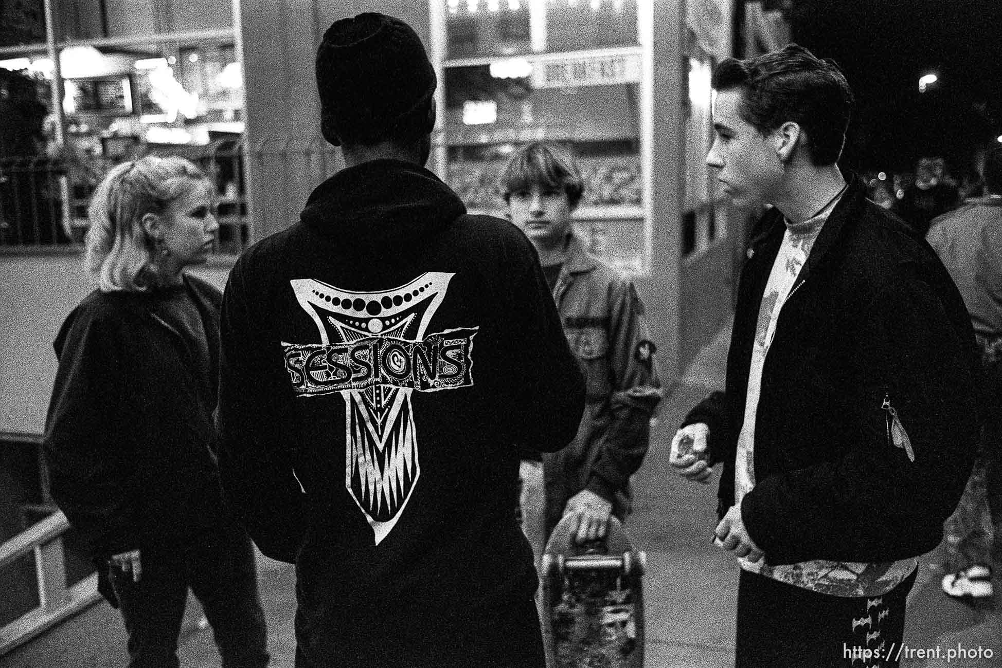 Skate punks on Telegraph Avenue at night.