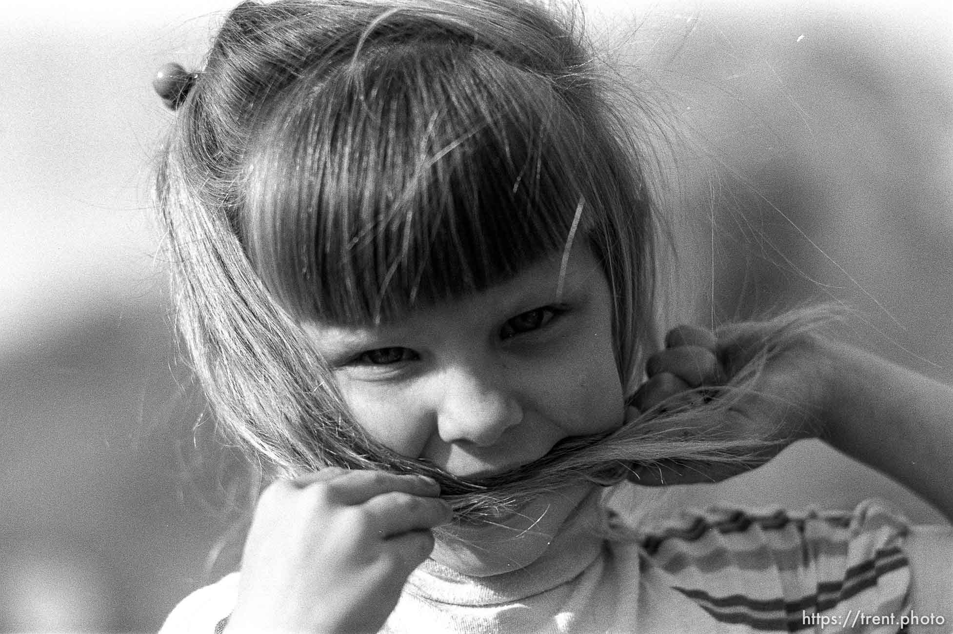 Girl with hair in her mouth.