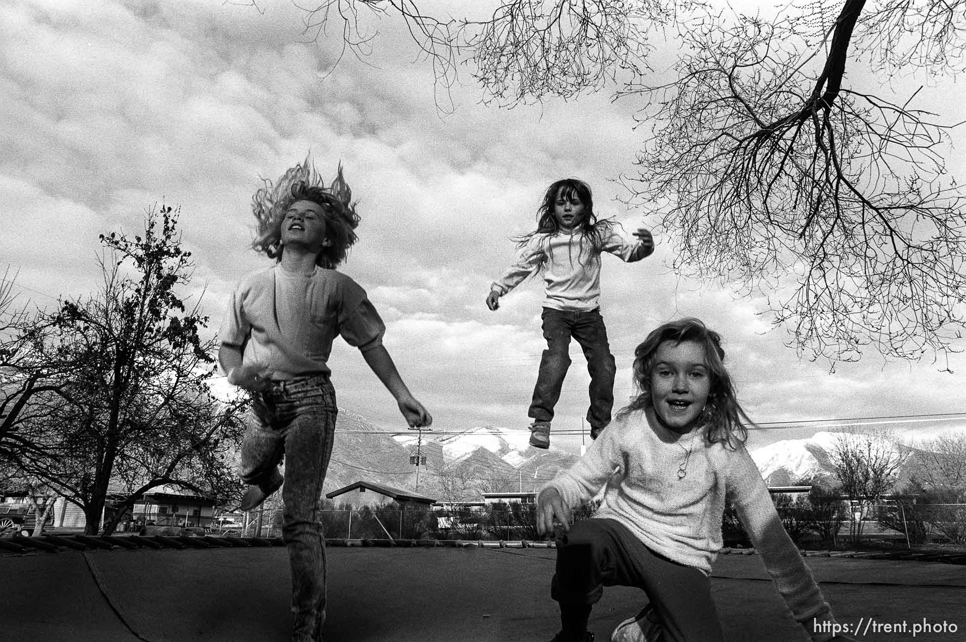 Kids jumping on trampoline.