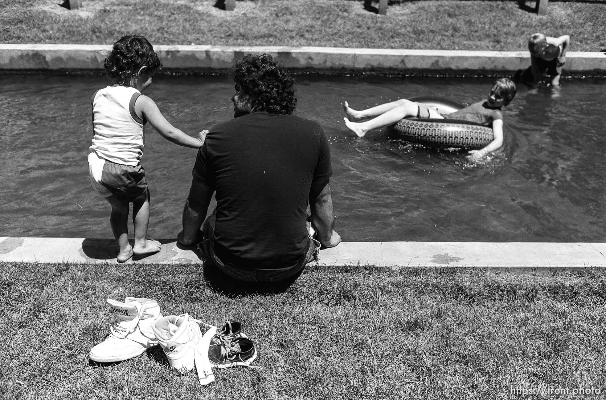 father and son and kids playing in canal.