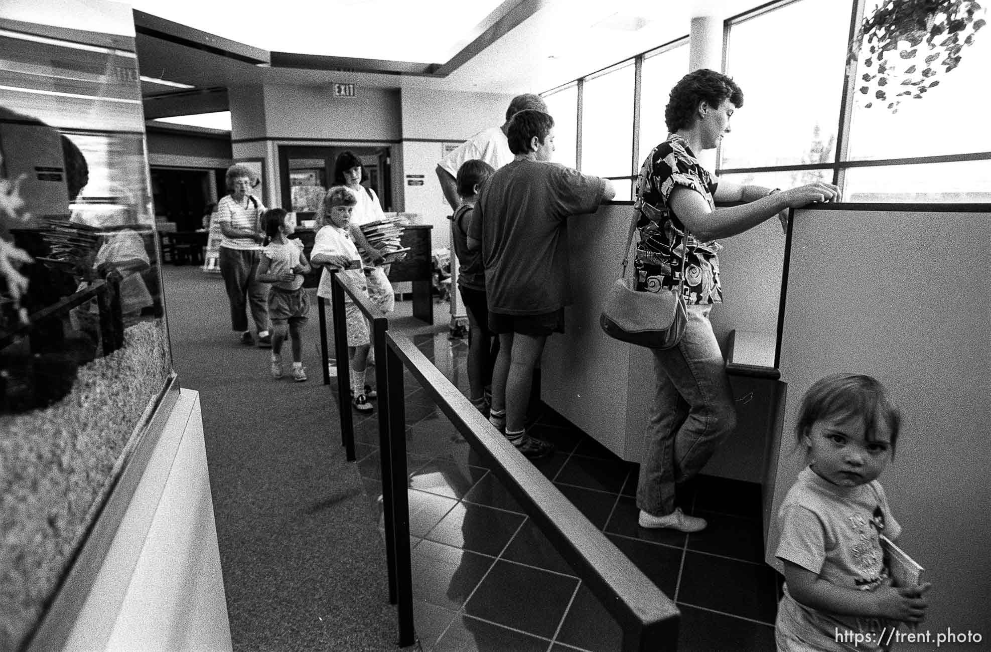 People wait in line to check out books for a story on the Provo Library being overcrowded.