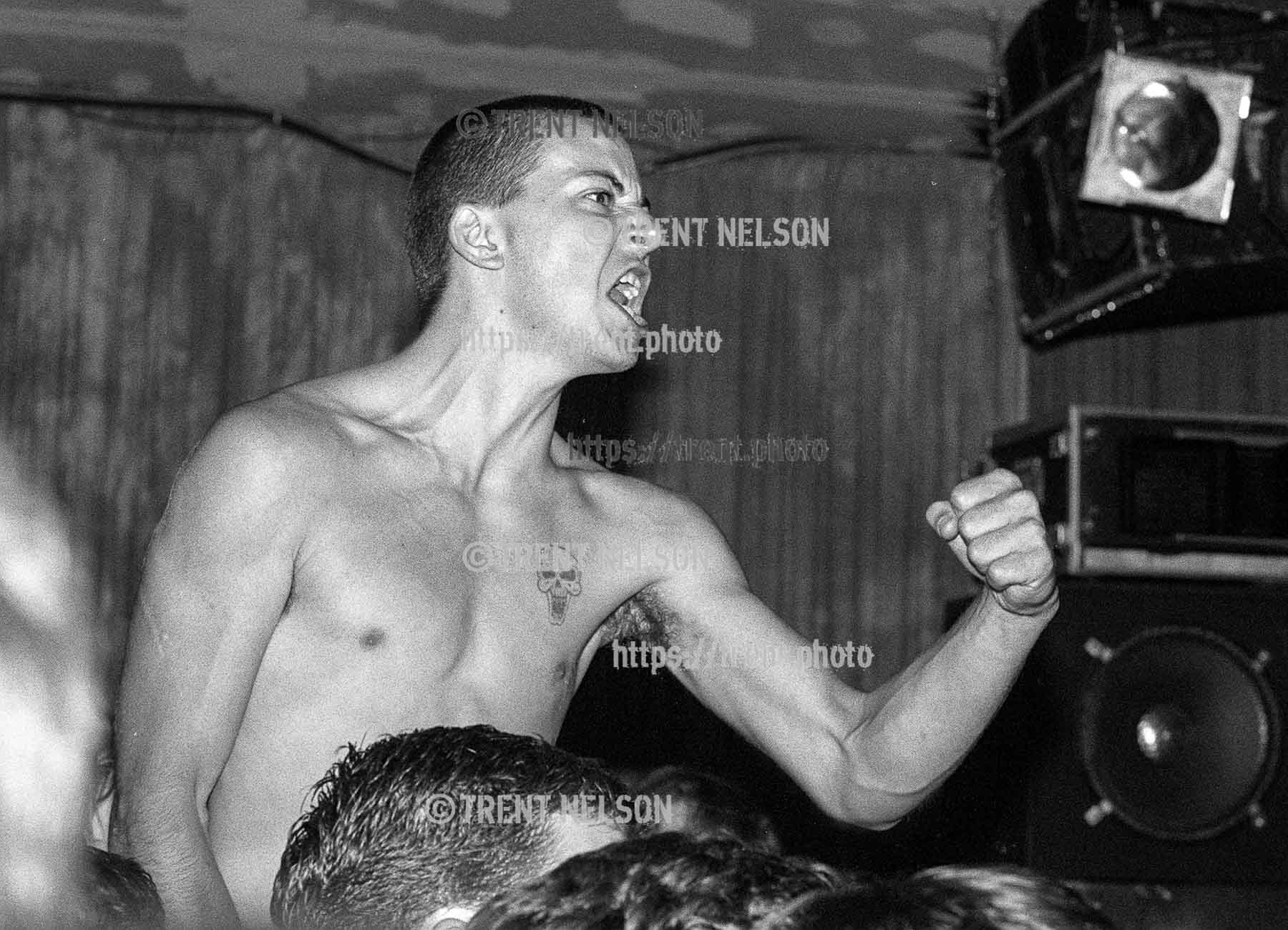 Racist skinhead charges the stage during Fugazi show at the Speedway Cafe.