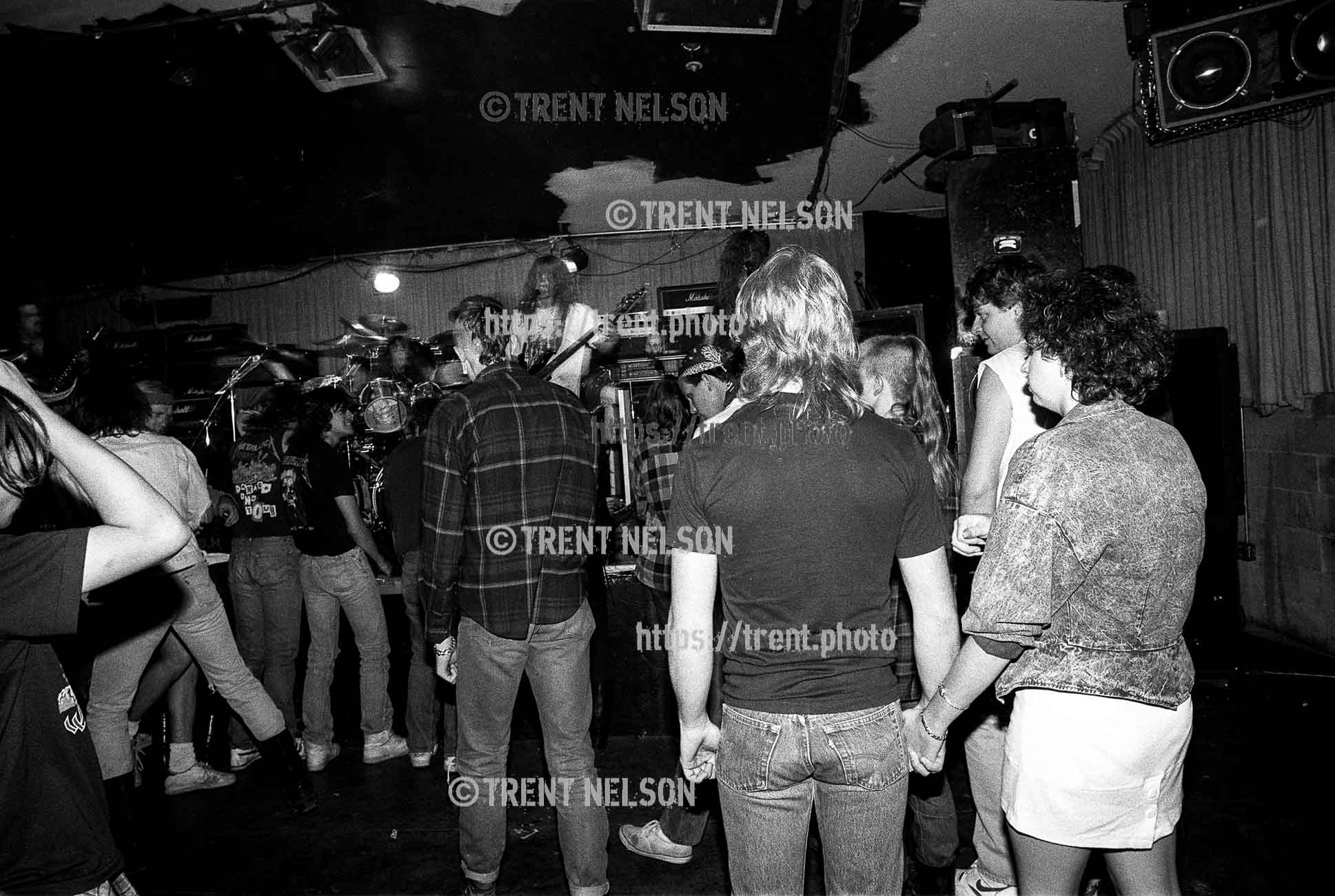 Couple holding hands in crowd during Slaughterchrist at the Speedway Cafe.