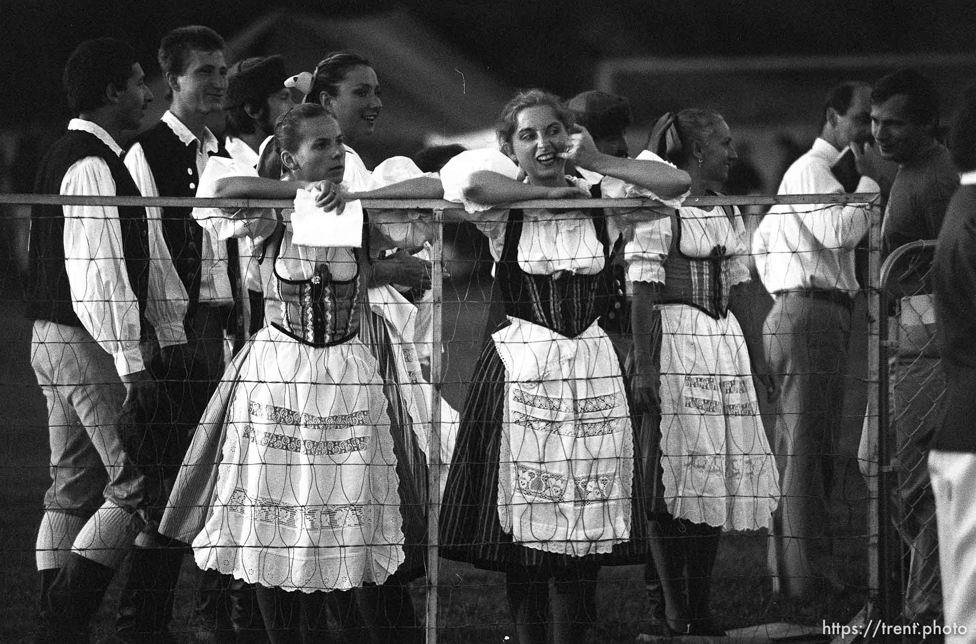 Dancers look over a fence at the International Folkfest.