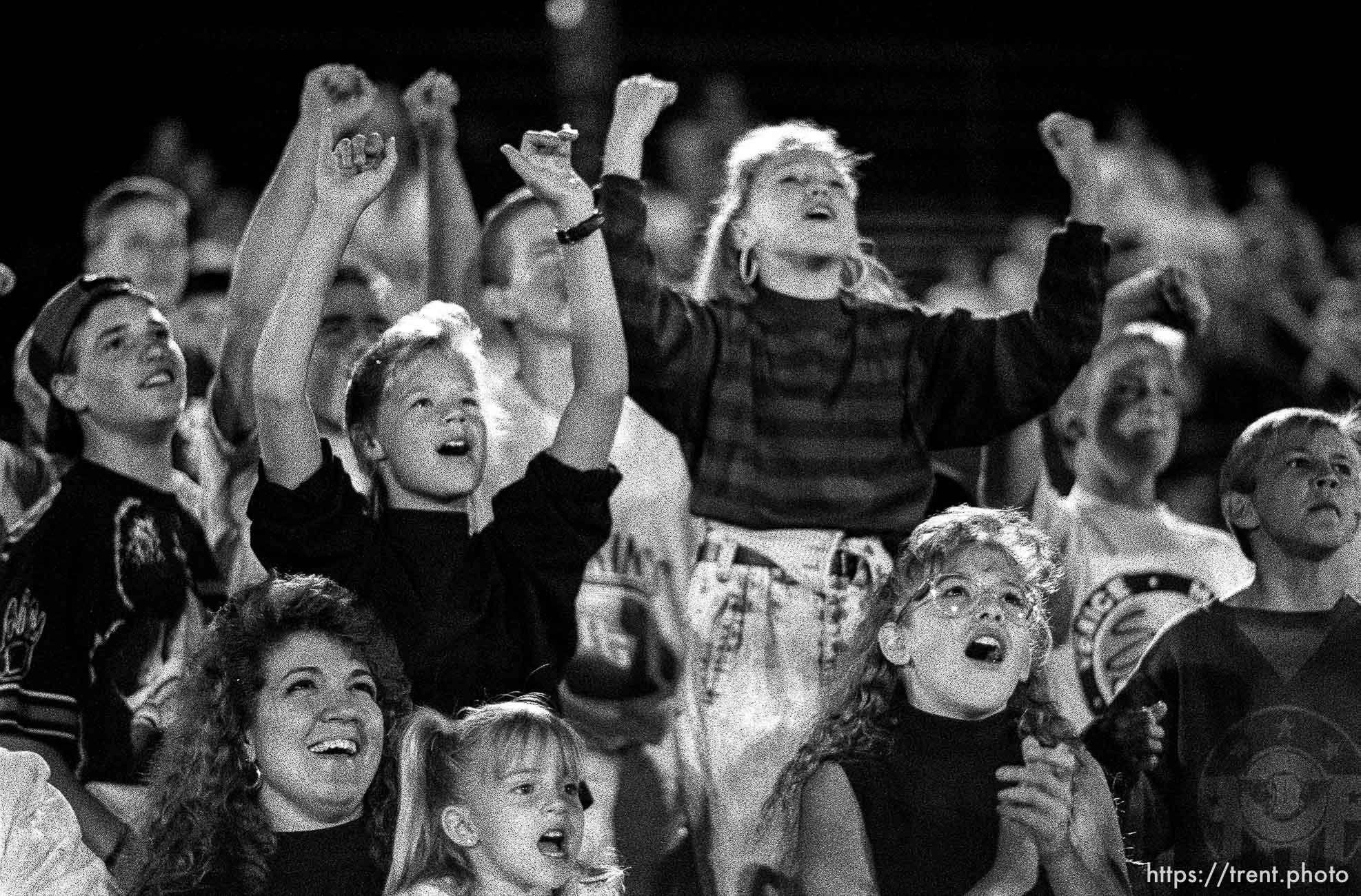 Girls go wild for wrestler at professional wrestling match.