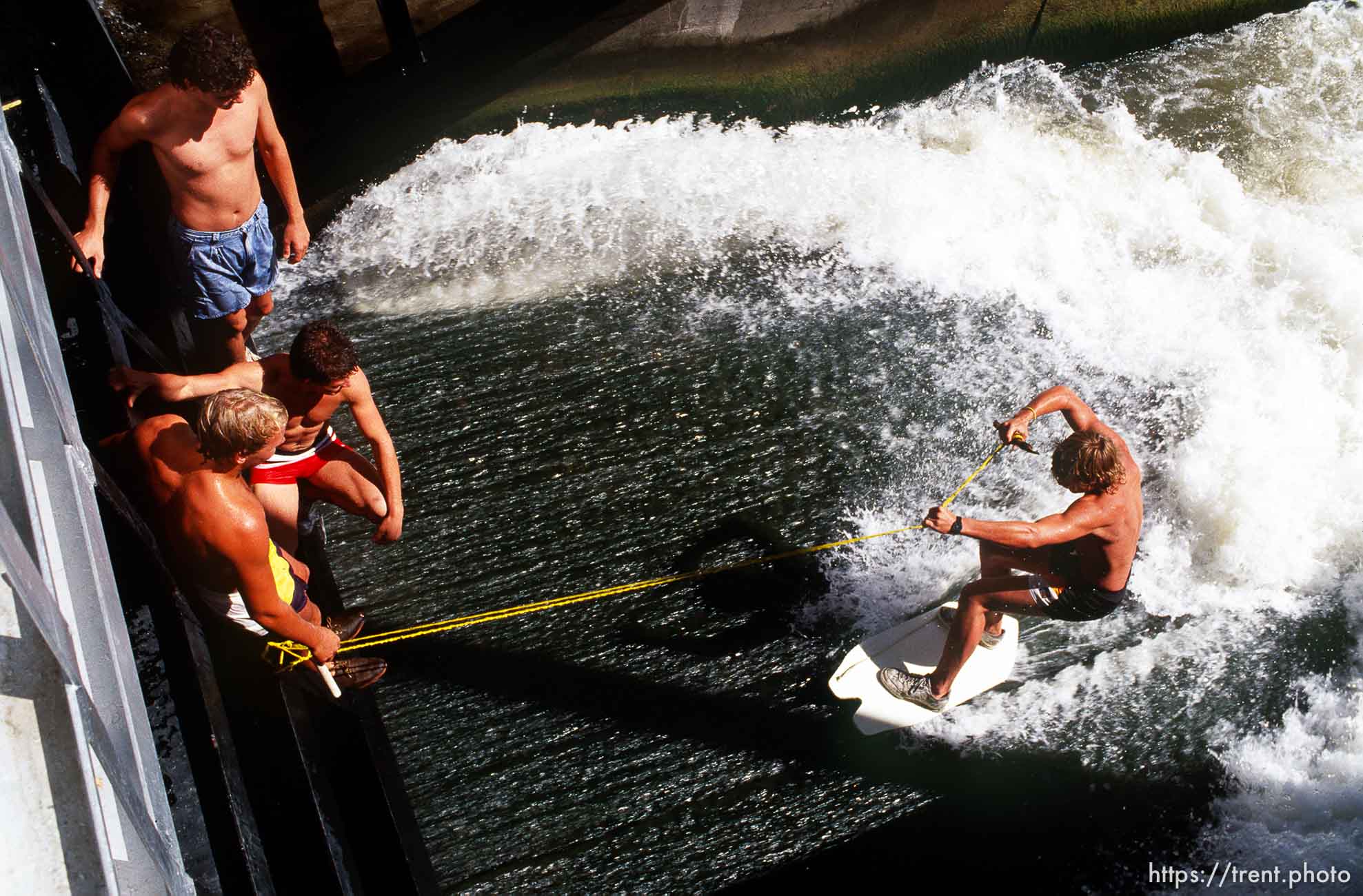 Kids surfing in waterway.