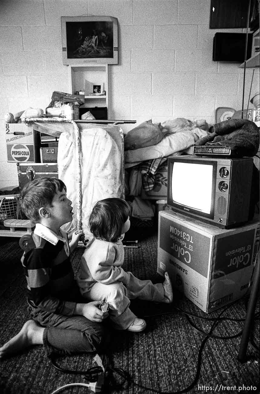 Kids watching tv. People living in the Hideaway Motel.