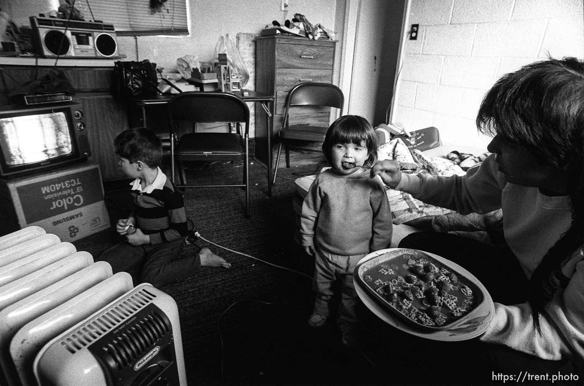 People living in the Hideaway Motel. Girl being fed.