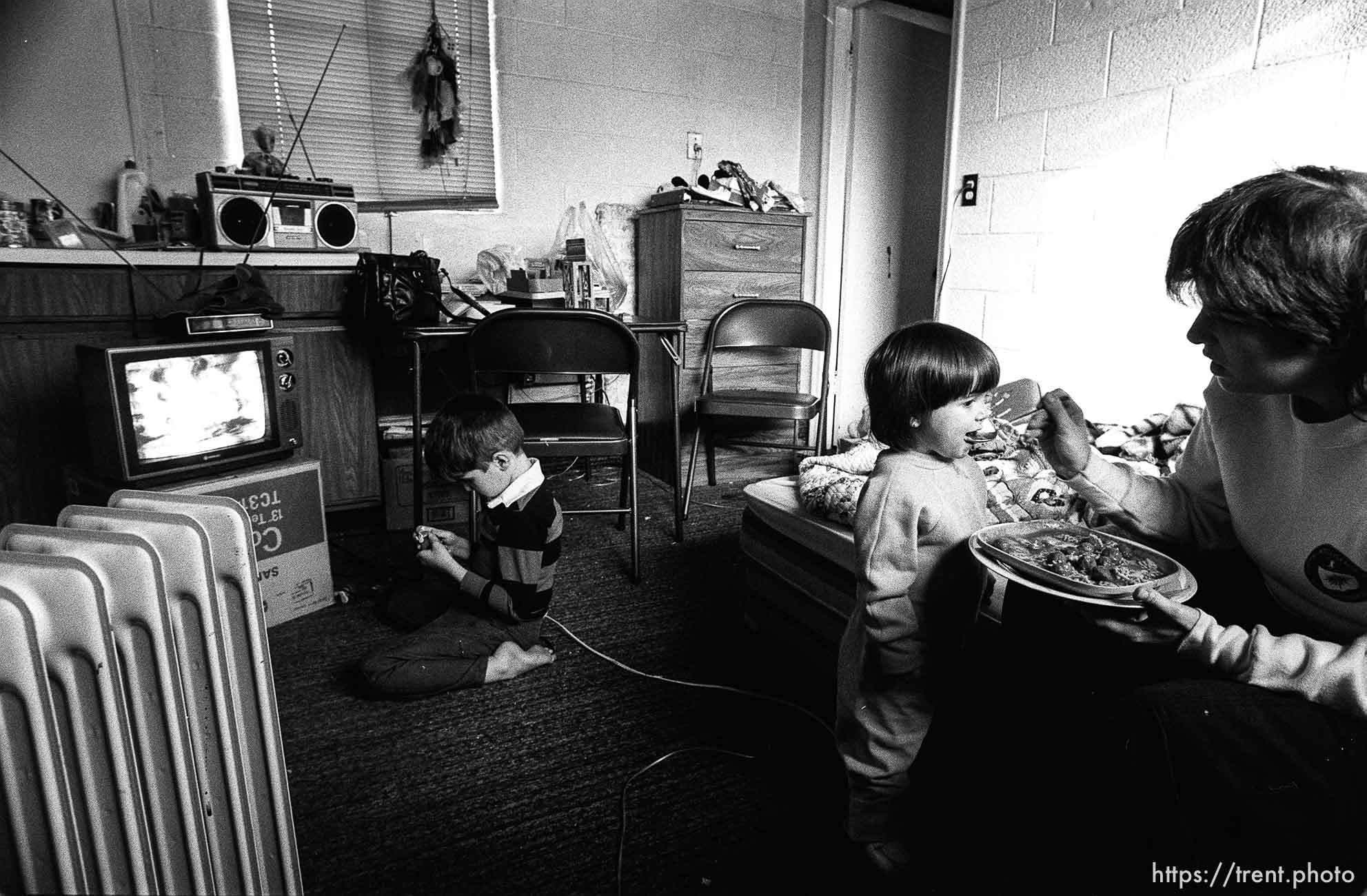 People living in the Hideaway Motel. Girl being fed.