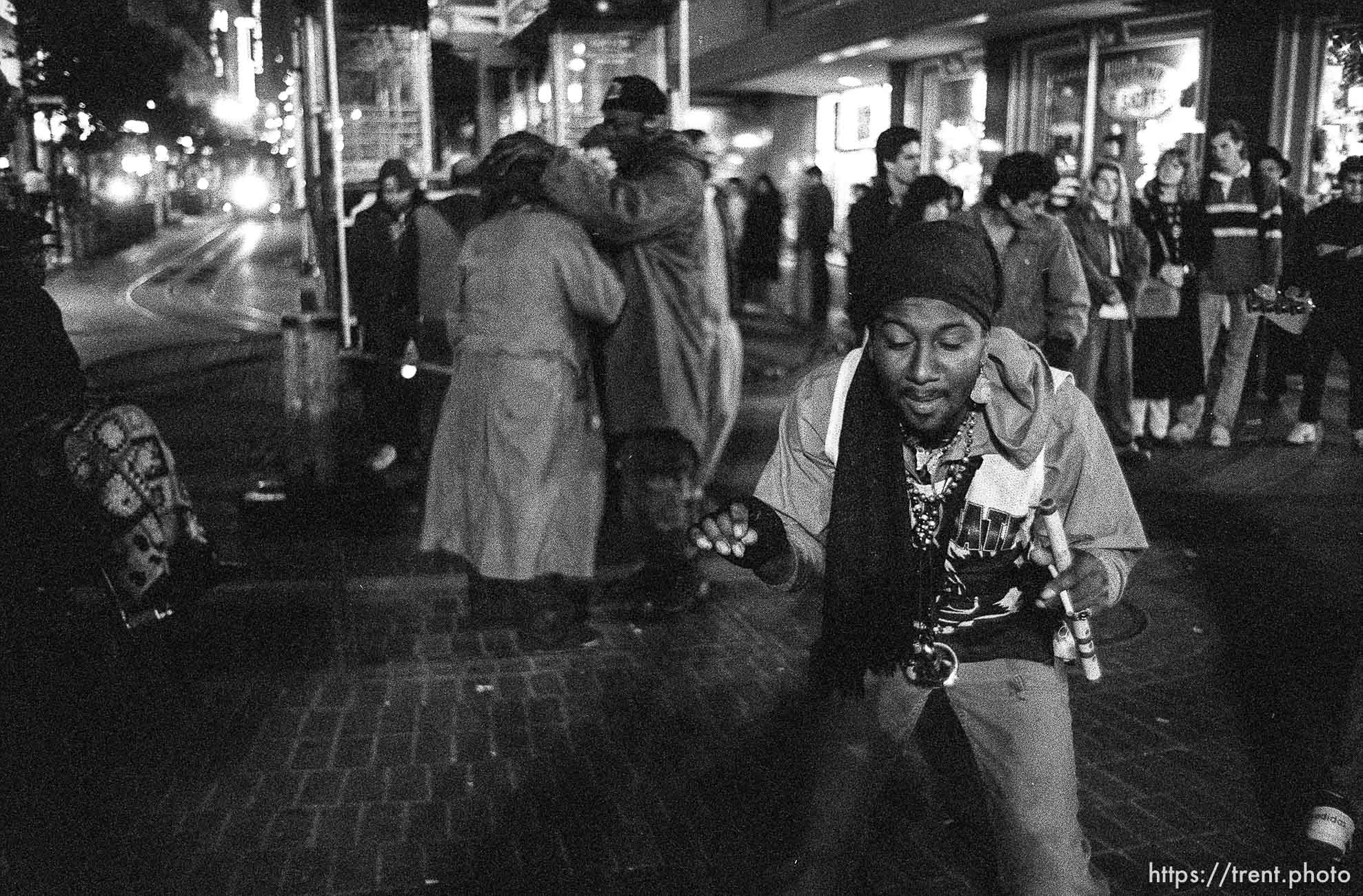 Man dancing on Market Street at night.