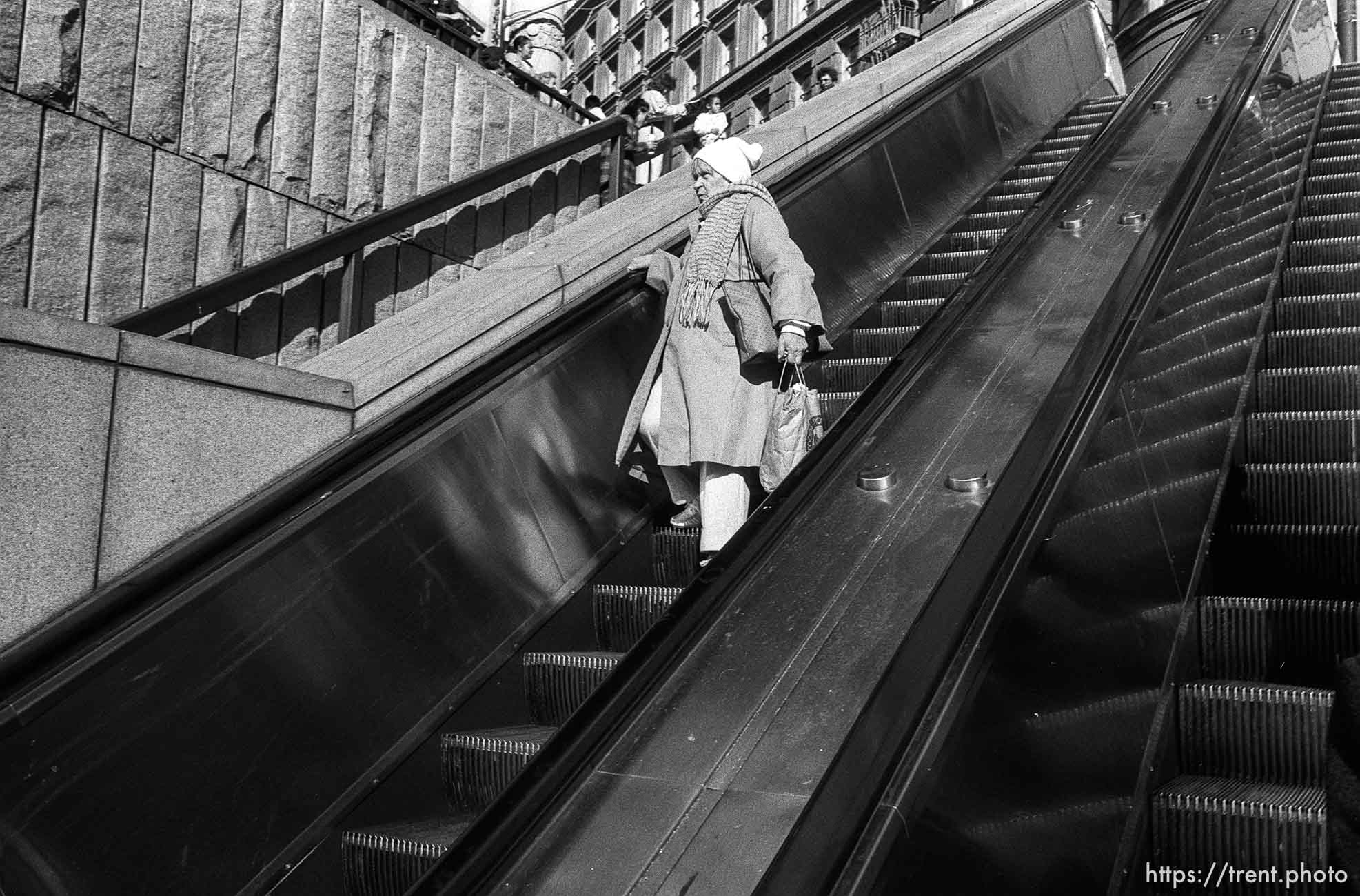 Woman on escalator on Market Street.