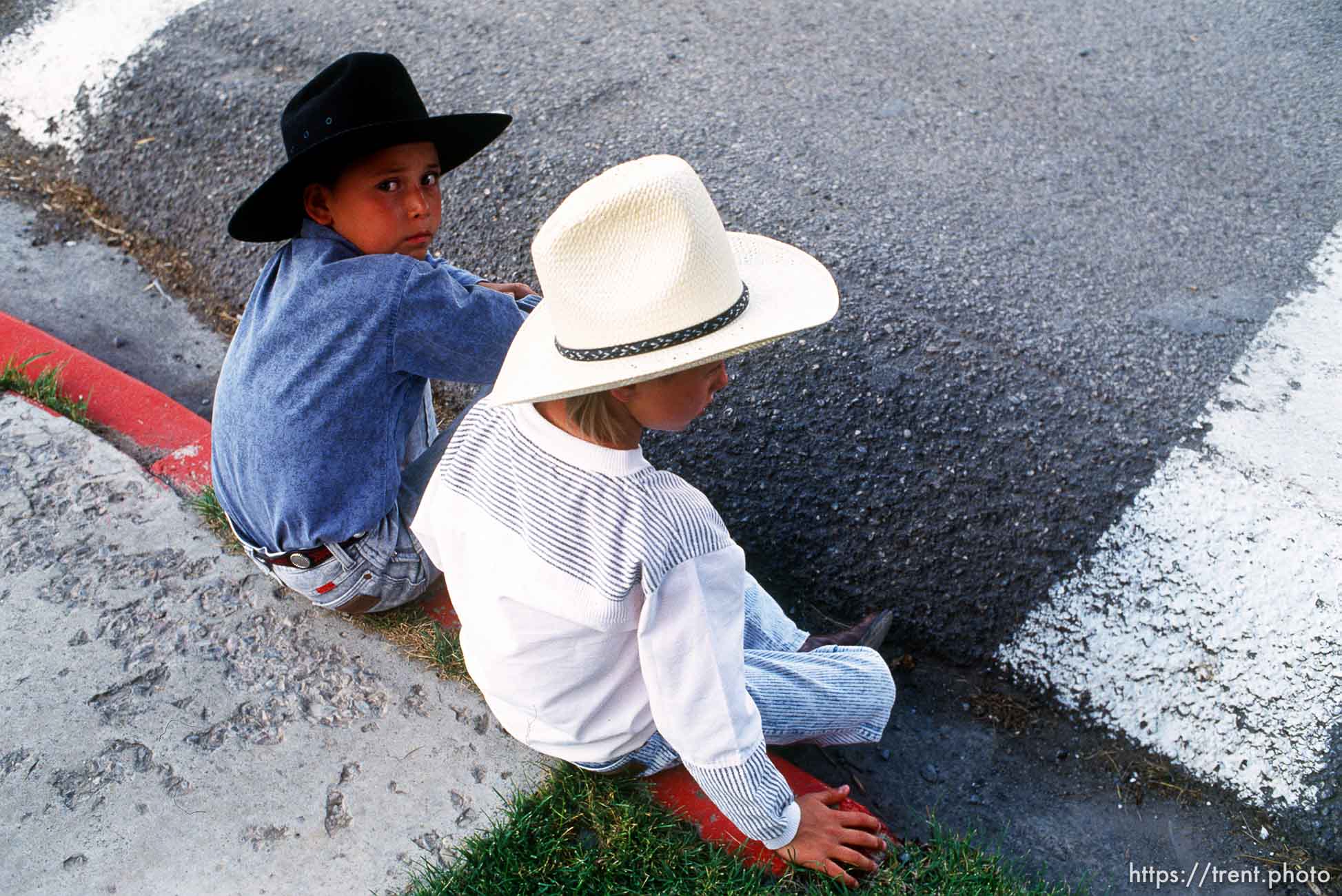 Kids with cowboy hats watching parade