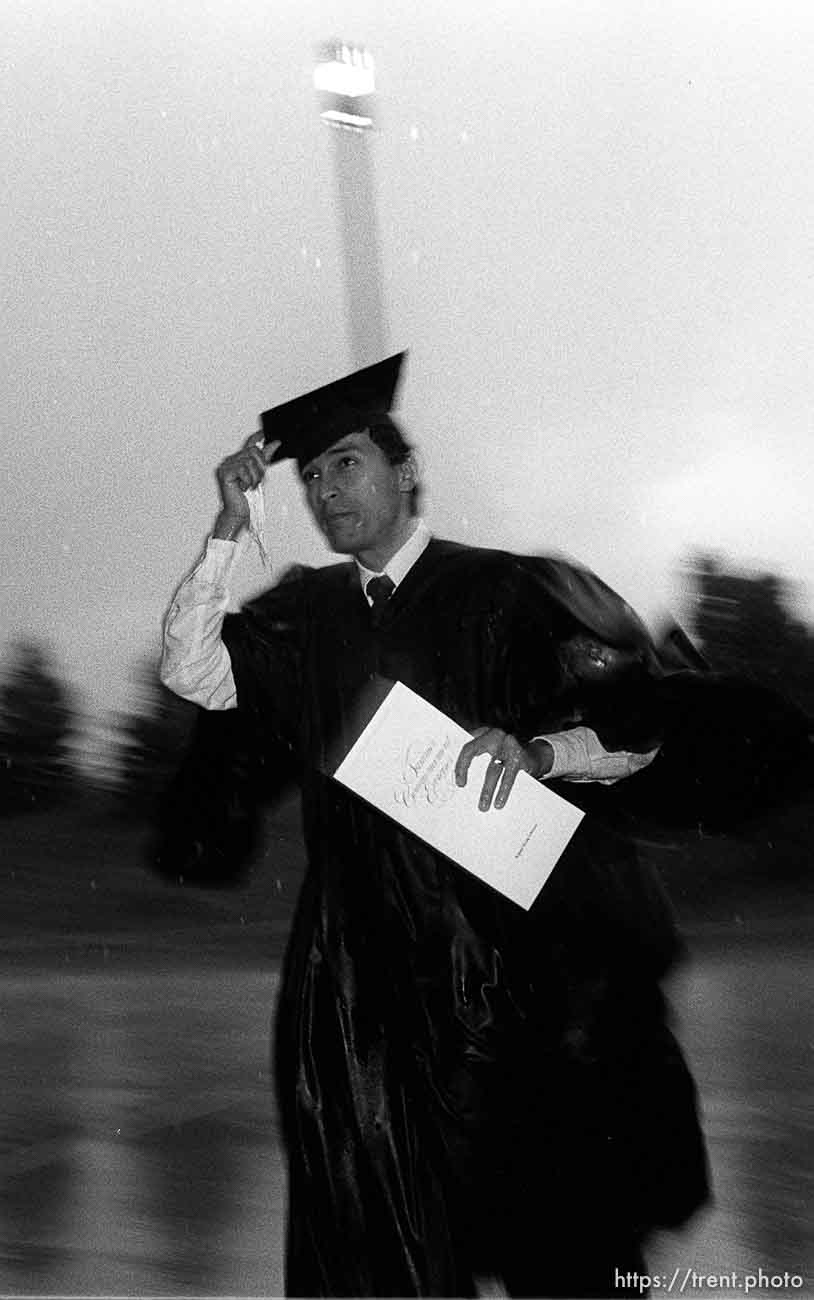 BYU graduates running to their graduation in the pouring rain.