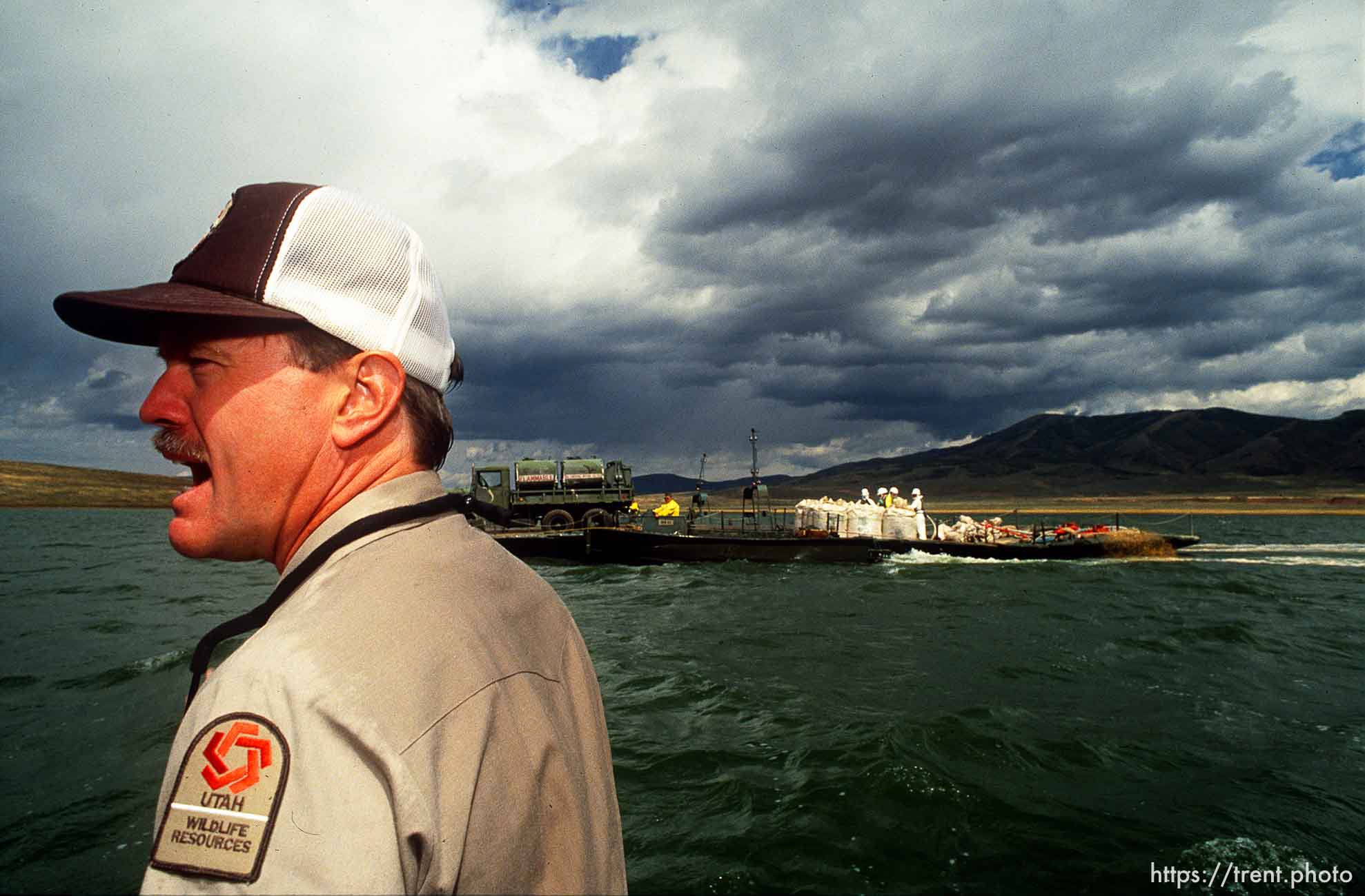 DWR guy explains to Governor Norm Bangerter the process by which poisons are dumped into Strawberry Reservoir to kill off all the fish in an attempt to purify the fish population.