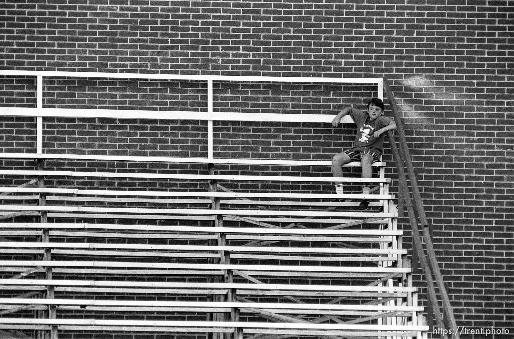 Lone fan, kid in the stands at American Fork football game.