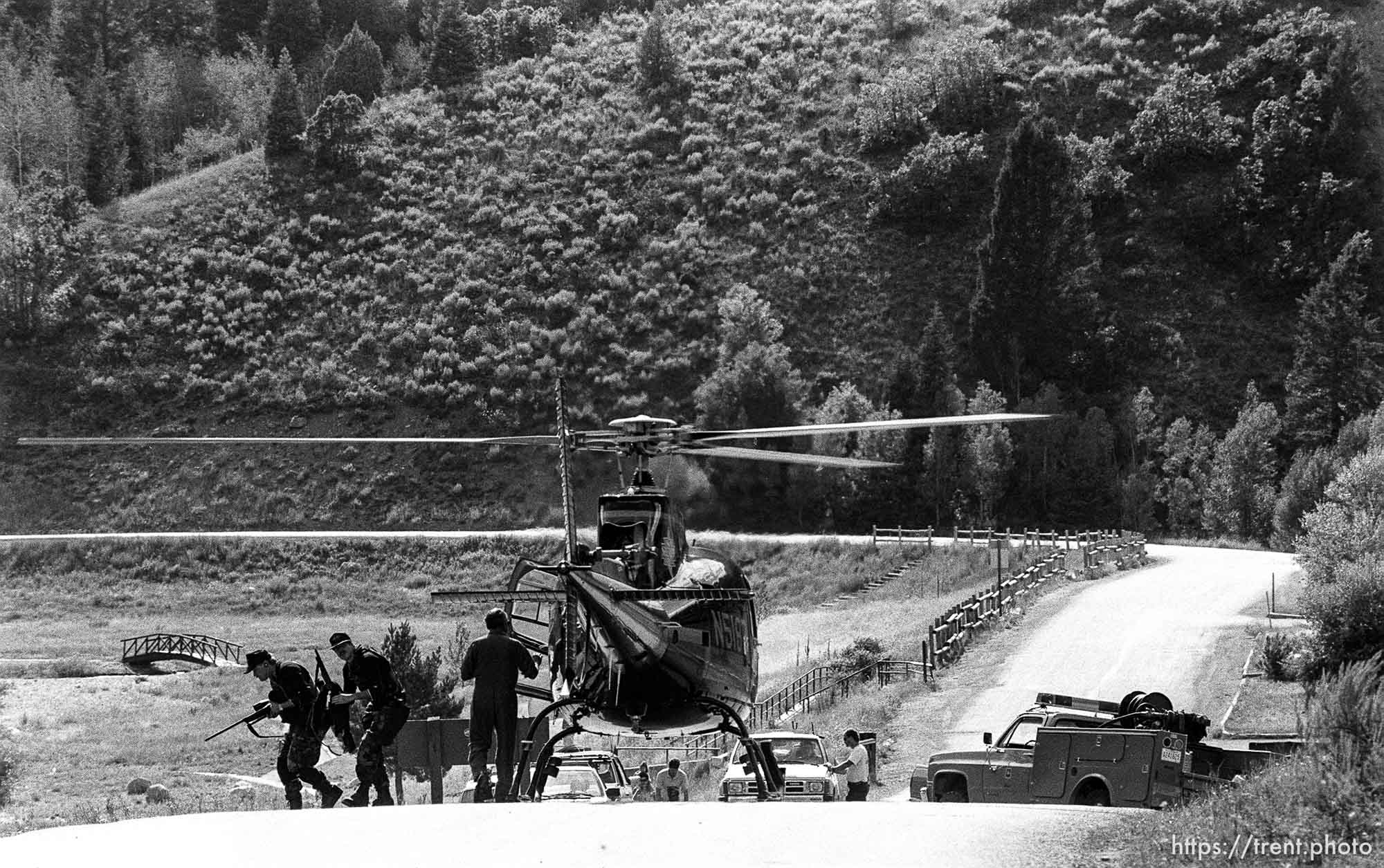 A helicopter and armed snipers during search for two prison escapees in American Fork Canyon.