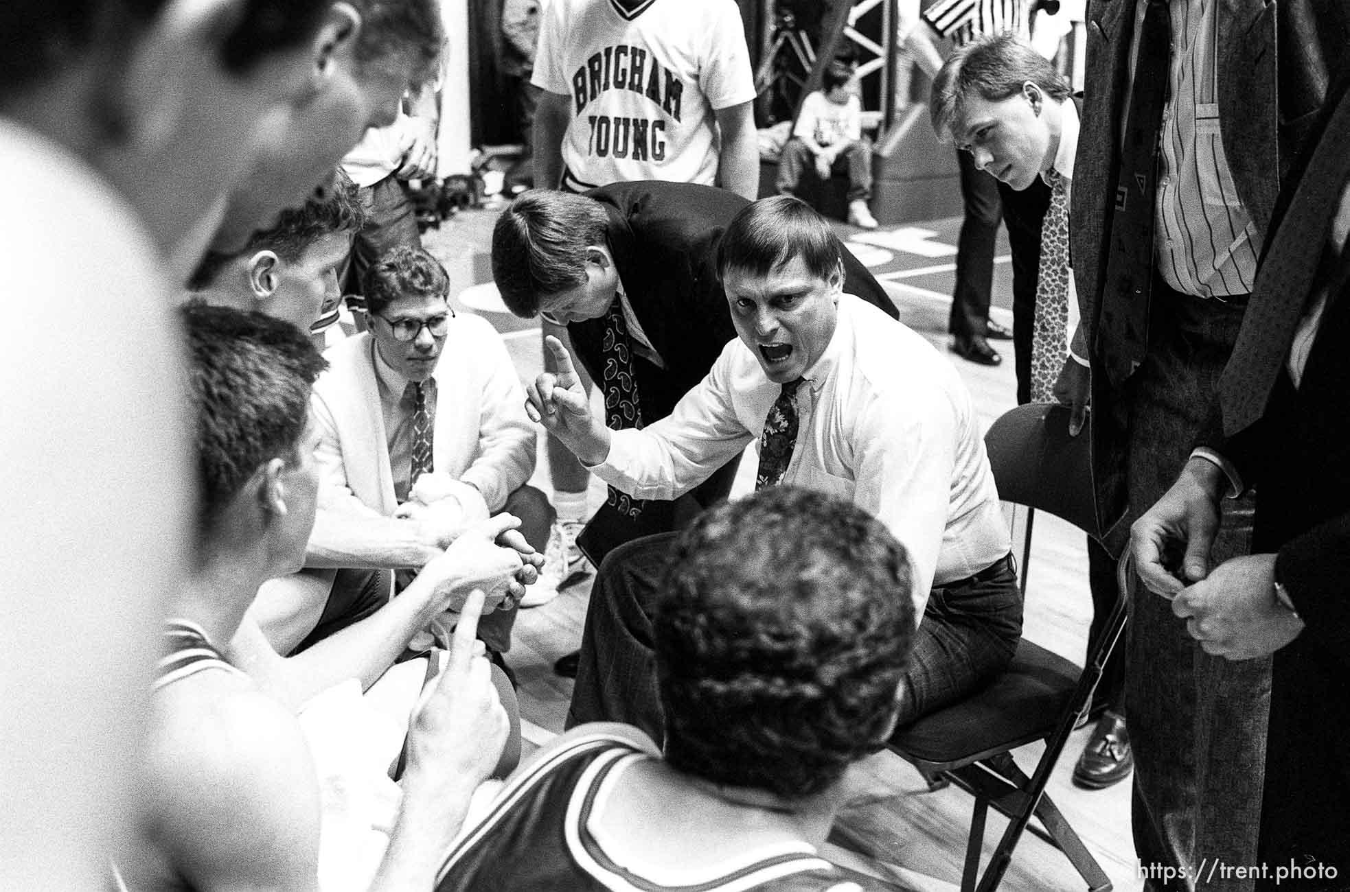 BYU coach Roger Reid in a timeout huddle at BYU vs. Weber State.