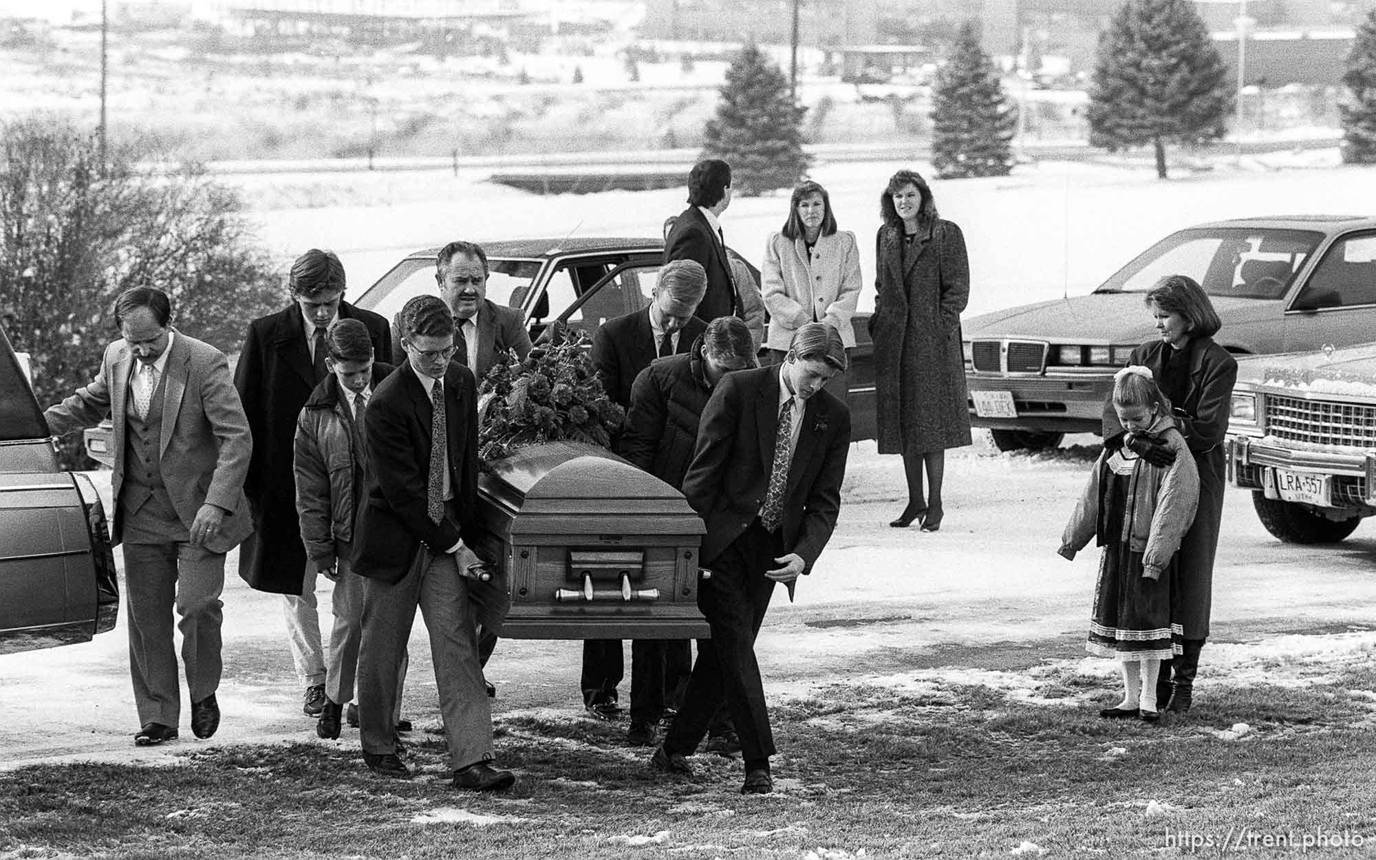 Family carrying casket at funeral of School superintendant (Moss).