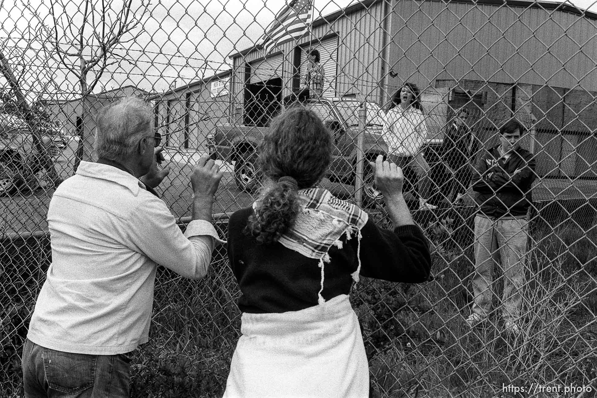 War protesters and pro-war people yell at each other through a fence at Gulf War protest at the Concord Naval Weapons Station.