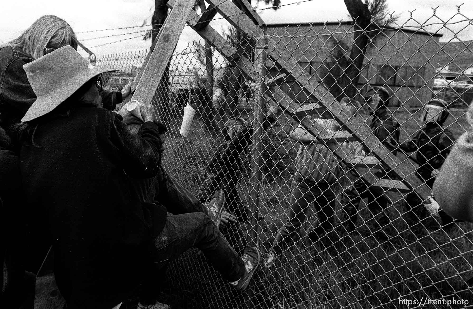 People fight over a ladder at Gulf War protest at the Concord Naval Weapons Station.