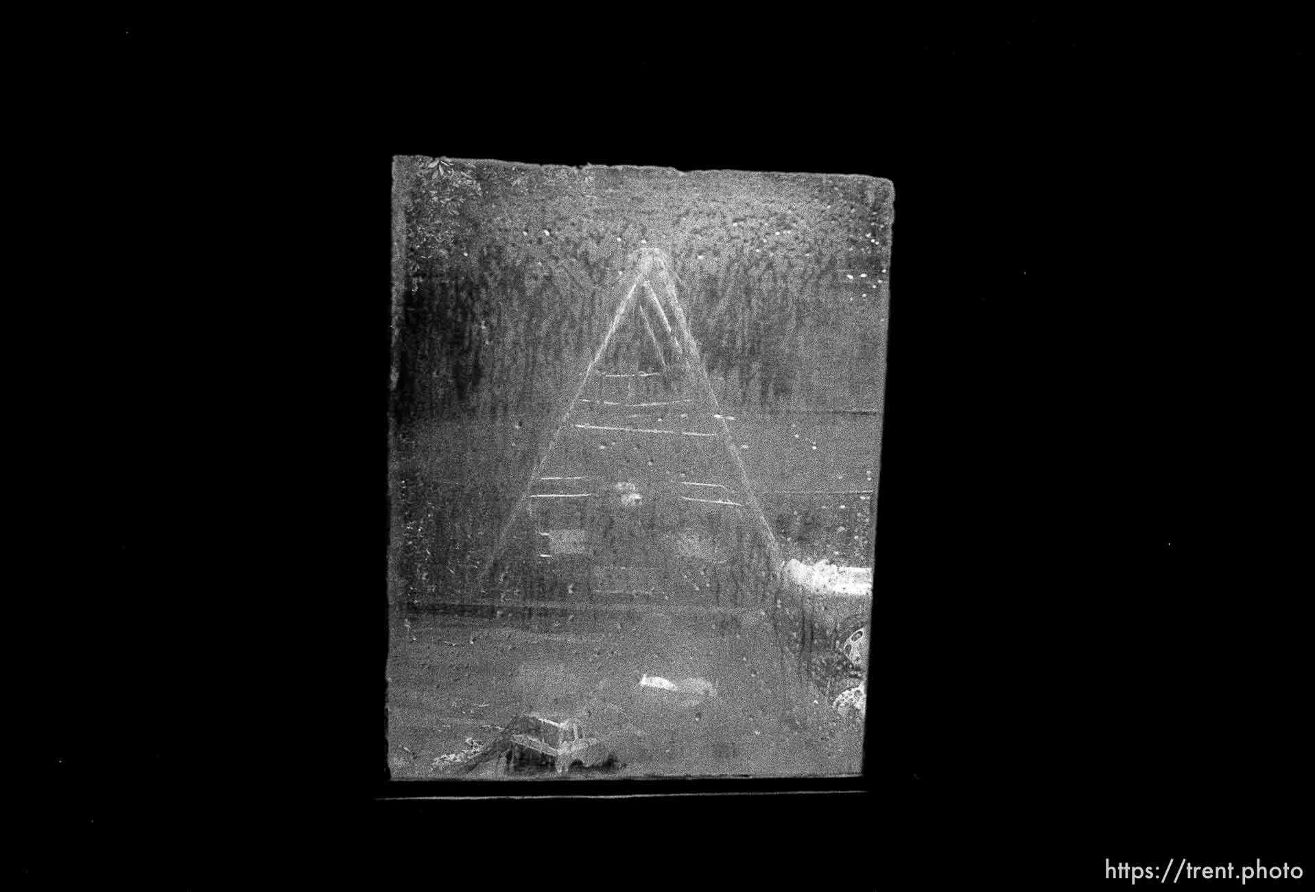 Swingset seen through wet, rainy window in playhouse