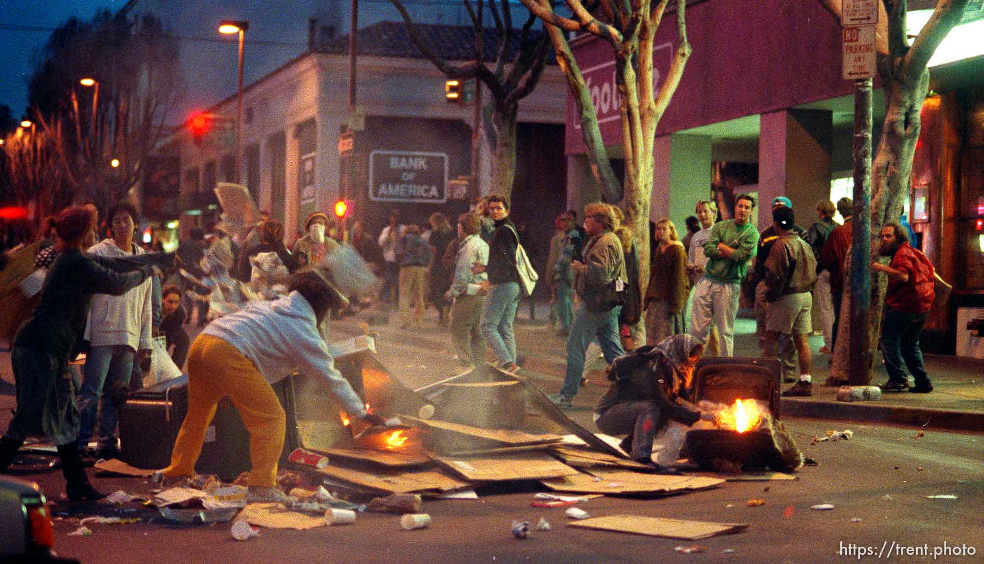 People starting fires in the street during riots and protests.