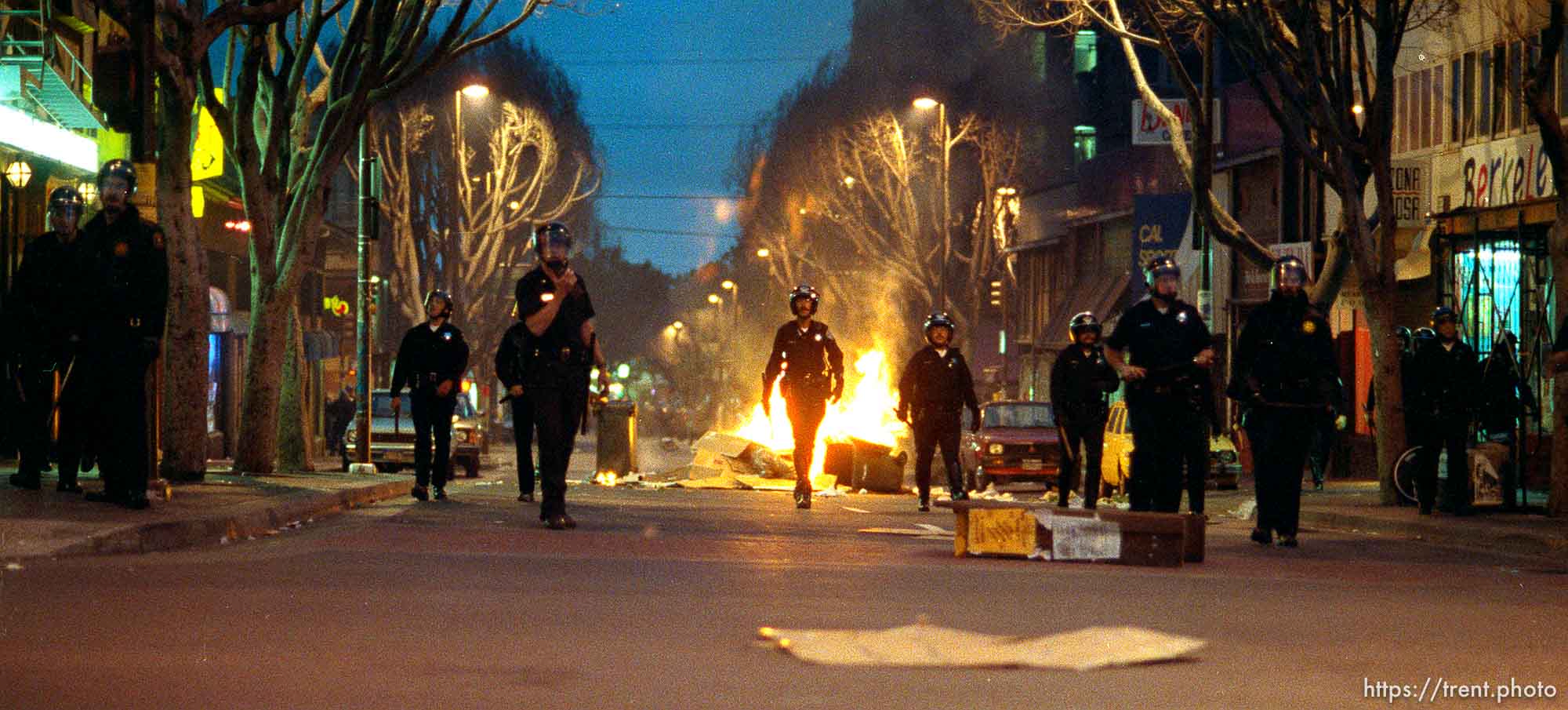 Police advance on rioters during riots and protests.