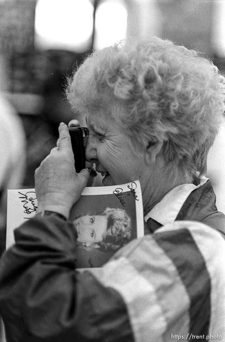 Woman takes a photo of Ms. America.