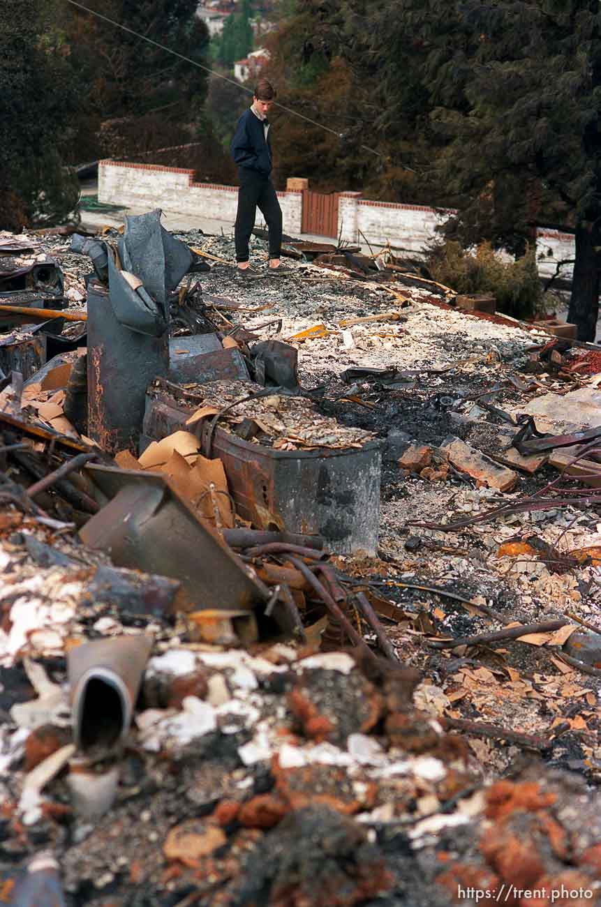 Family searching remains of home destroyed in Oakland Hills fire.