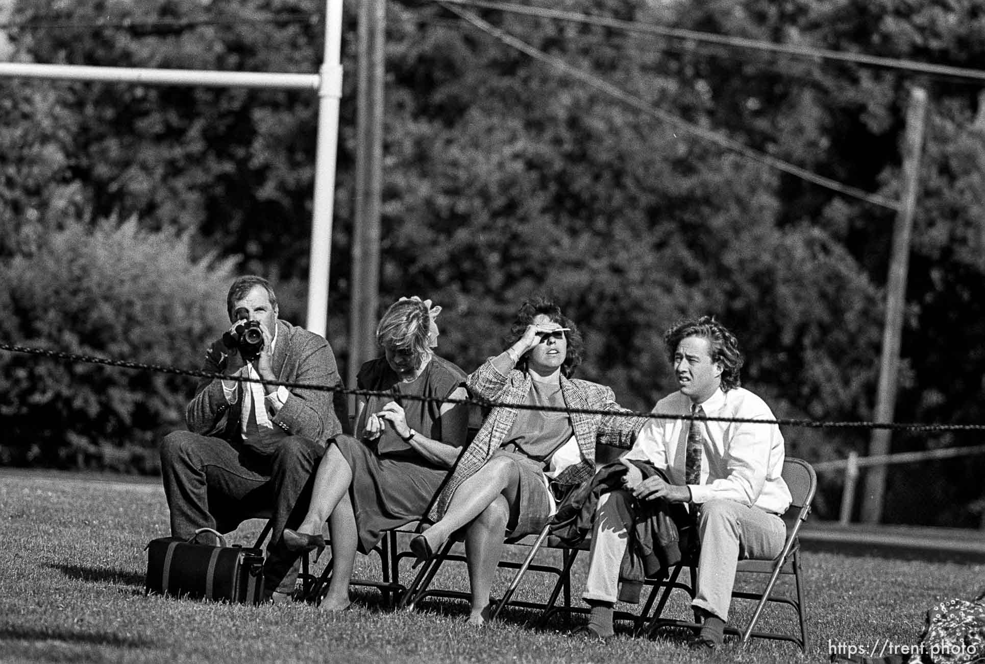 Parents and friends at Acalanes High School graduation. Man with videocamera