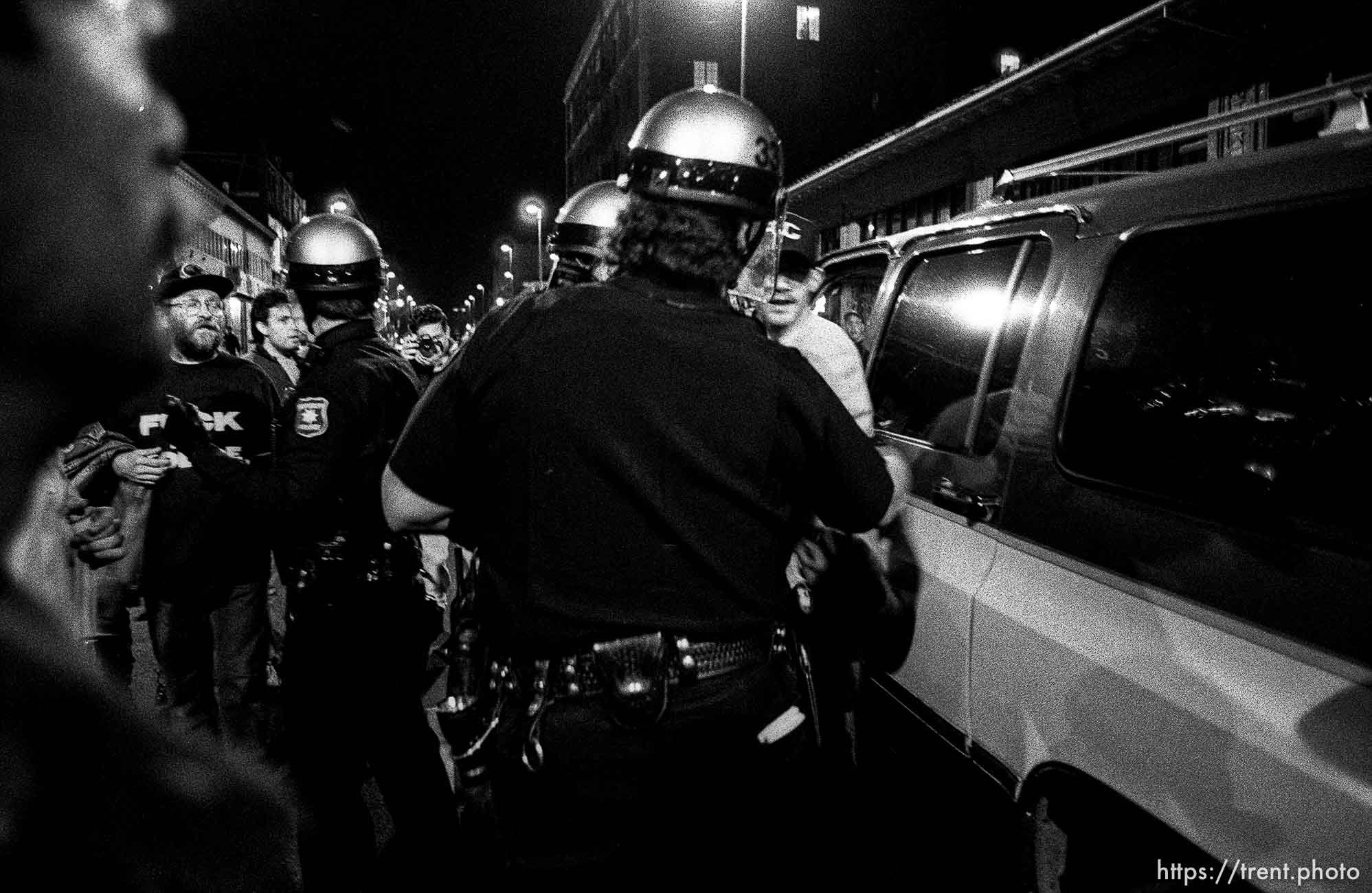 Police arrest man with baseball bat at Rosebud protest. Dave Lowe shooting in background