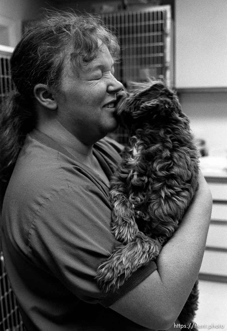 Nurse kissing dog at the Lafayette Animal Hospital