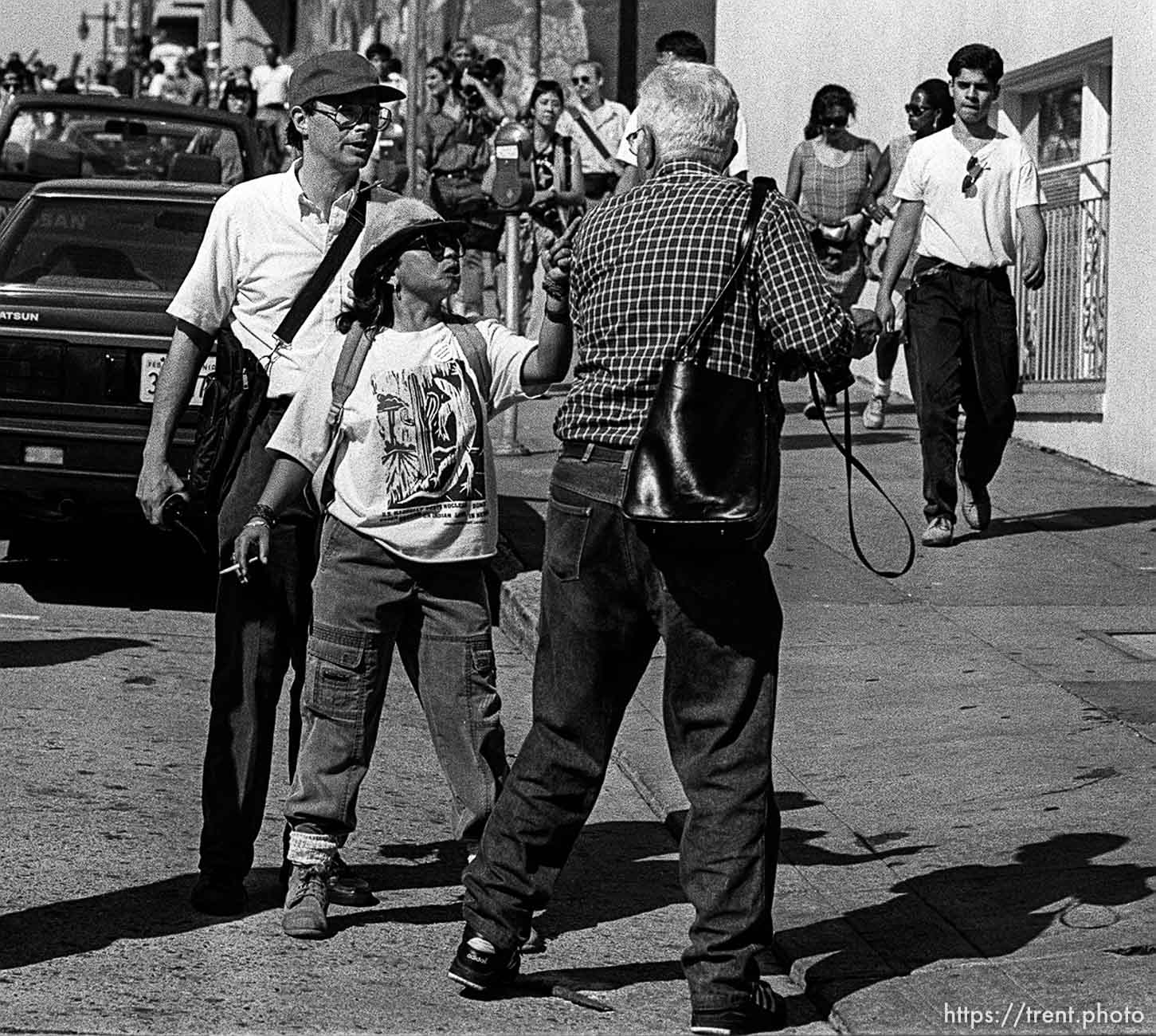 American Indian Movement woman threatens photographer at anti-Christopher Columbus protest.