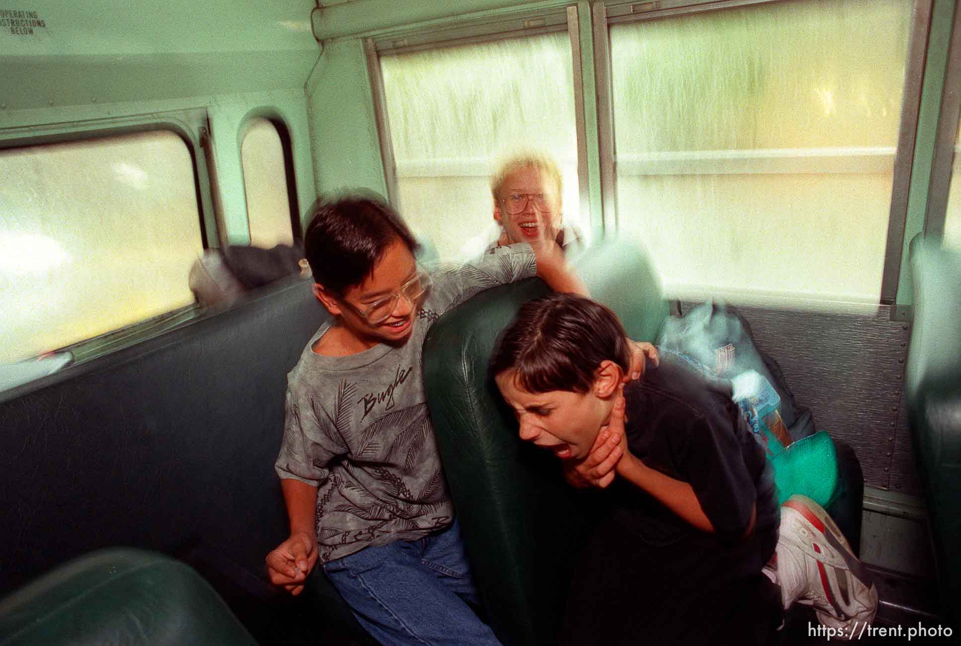 Kids fighting on school bus.