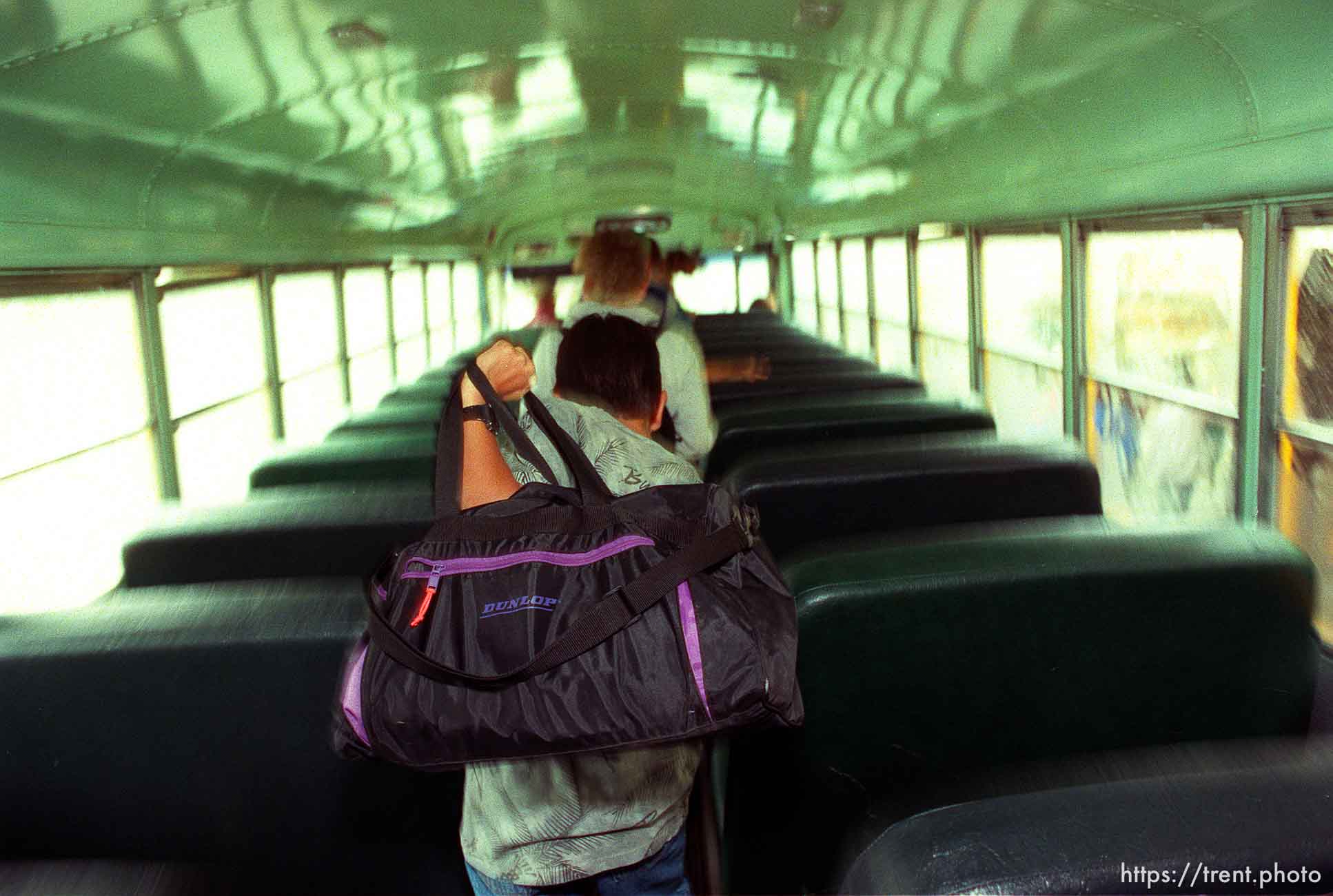 Kids getting off of school bus.