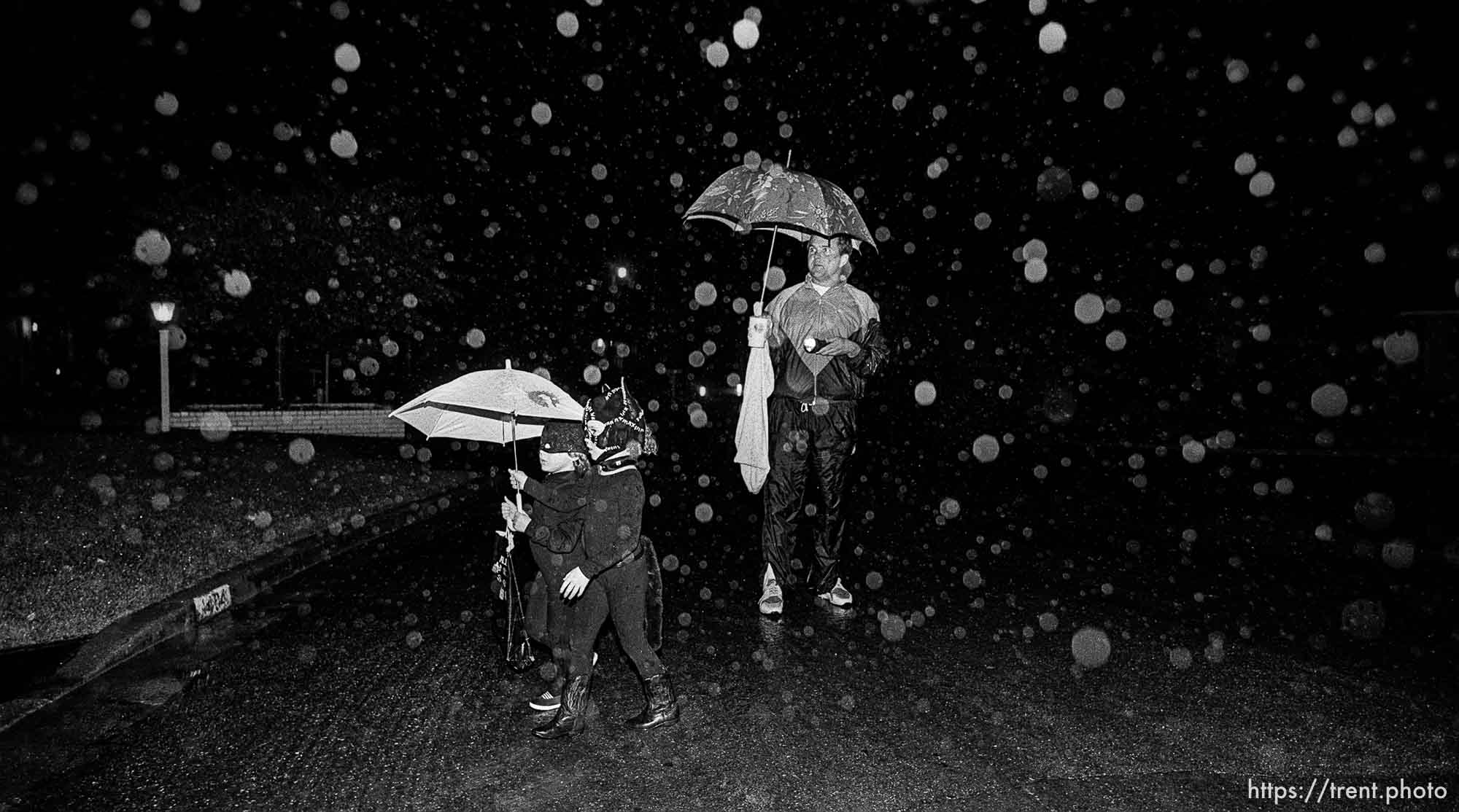 Trick-or-treaters in rain on Halloween